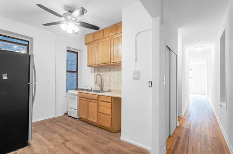 a view of a kitchen with a sink and a refrigerator