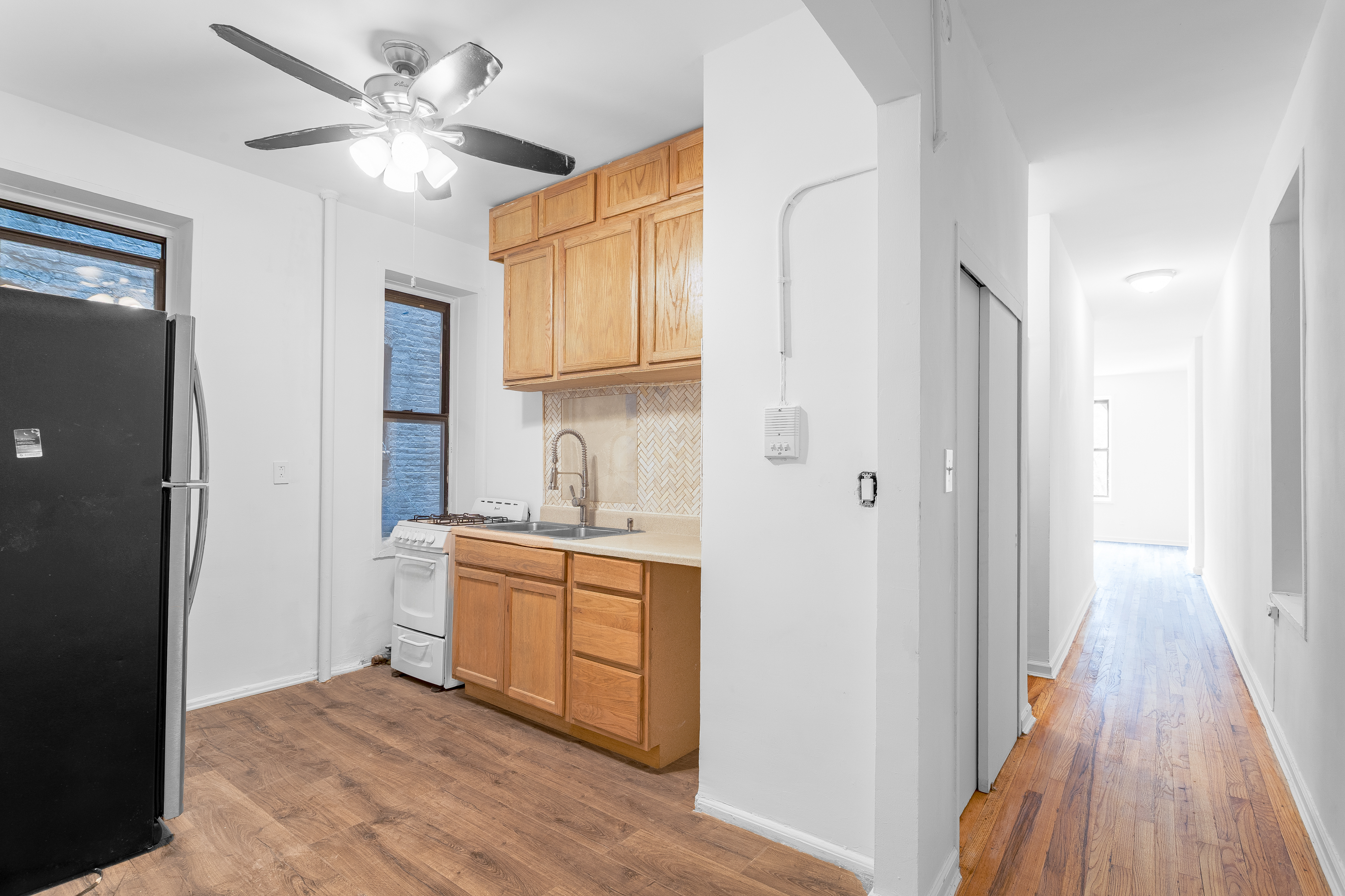 157 West 123rd Street, Unit 2A Manhattan, NY 10027 - Photo 6 of 16 a view of a kitchen with a sink and a refrigerator