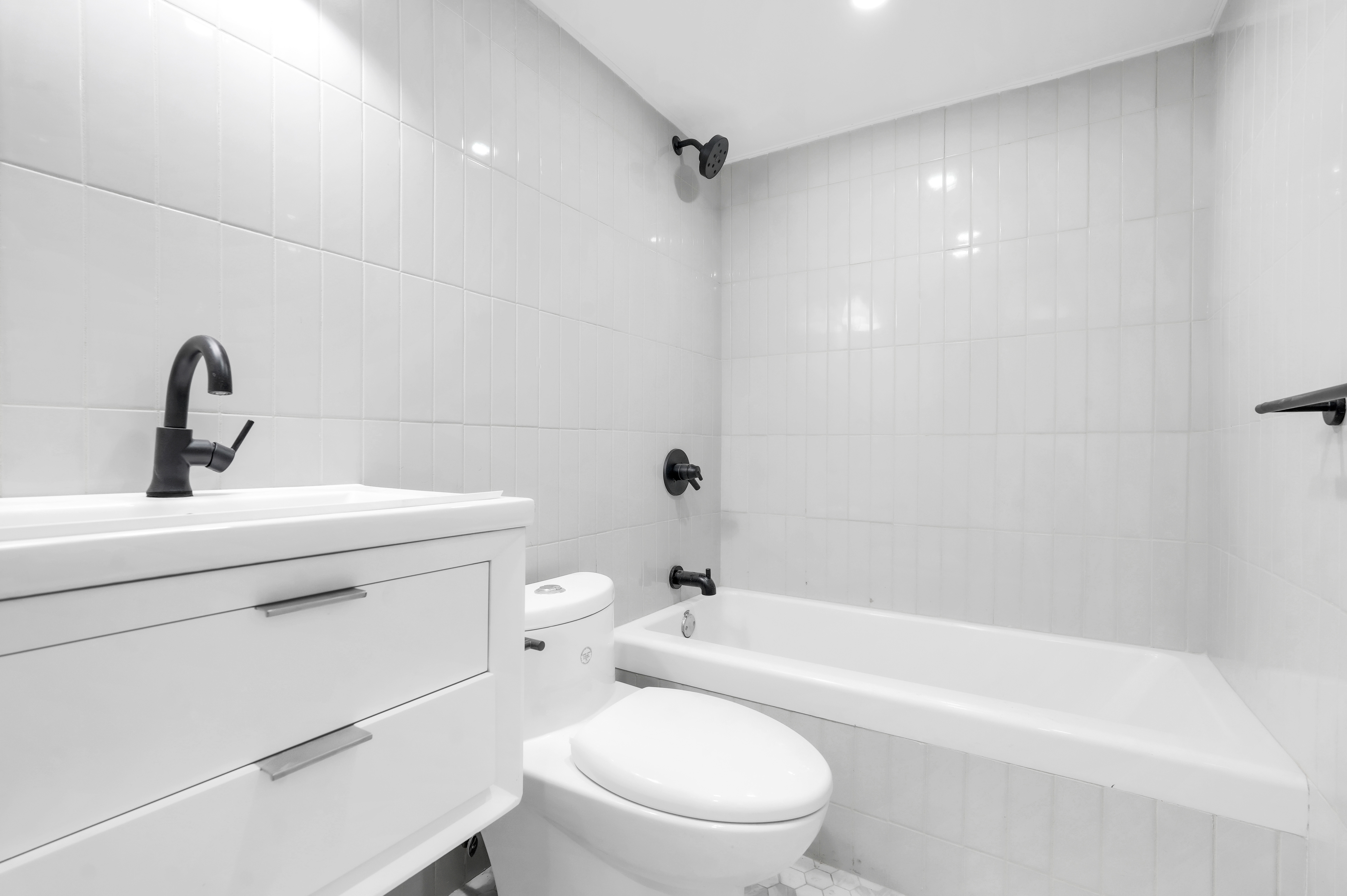 473 Monroe Street Brooklyn, NY 11221 - Photo 35 of 40 a bathroom with a toilet a sink and bathtub