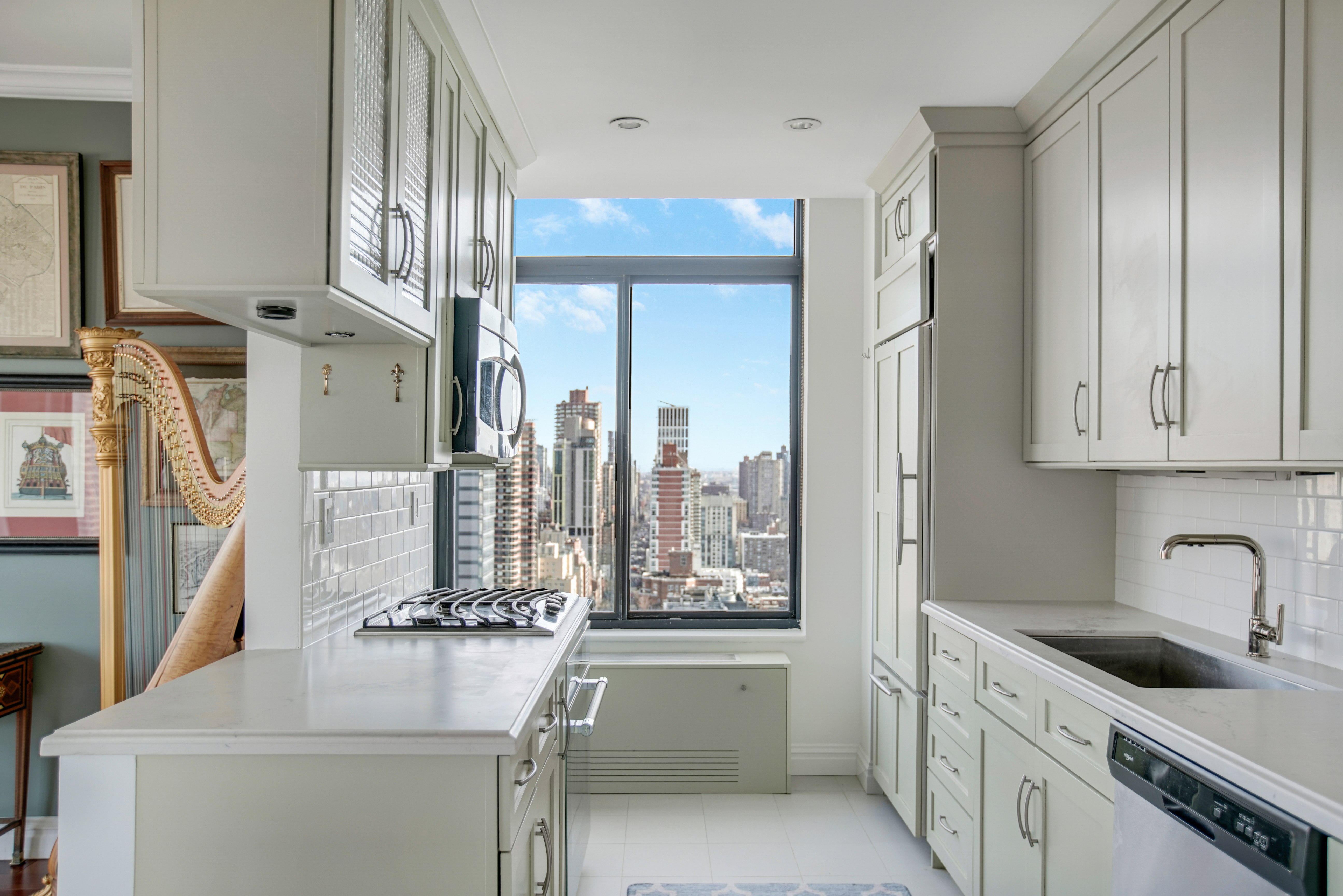 400 East 70th Street, Unit 3301 Manhattan, NY 10021 - Photo 7 of 20 a kitchen with a sink stove and cabinets