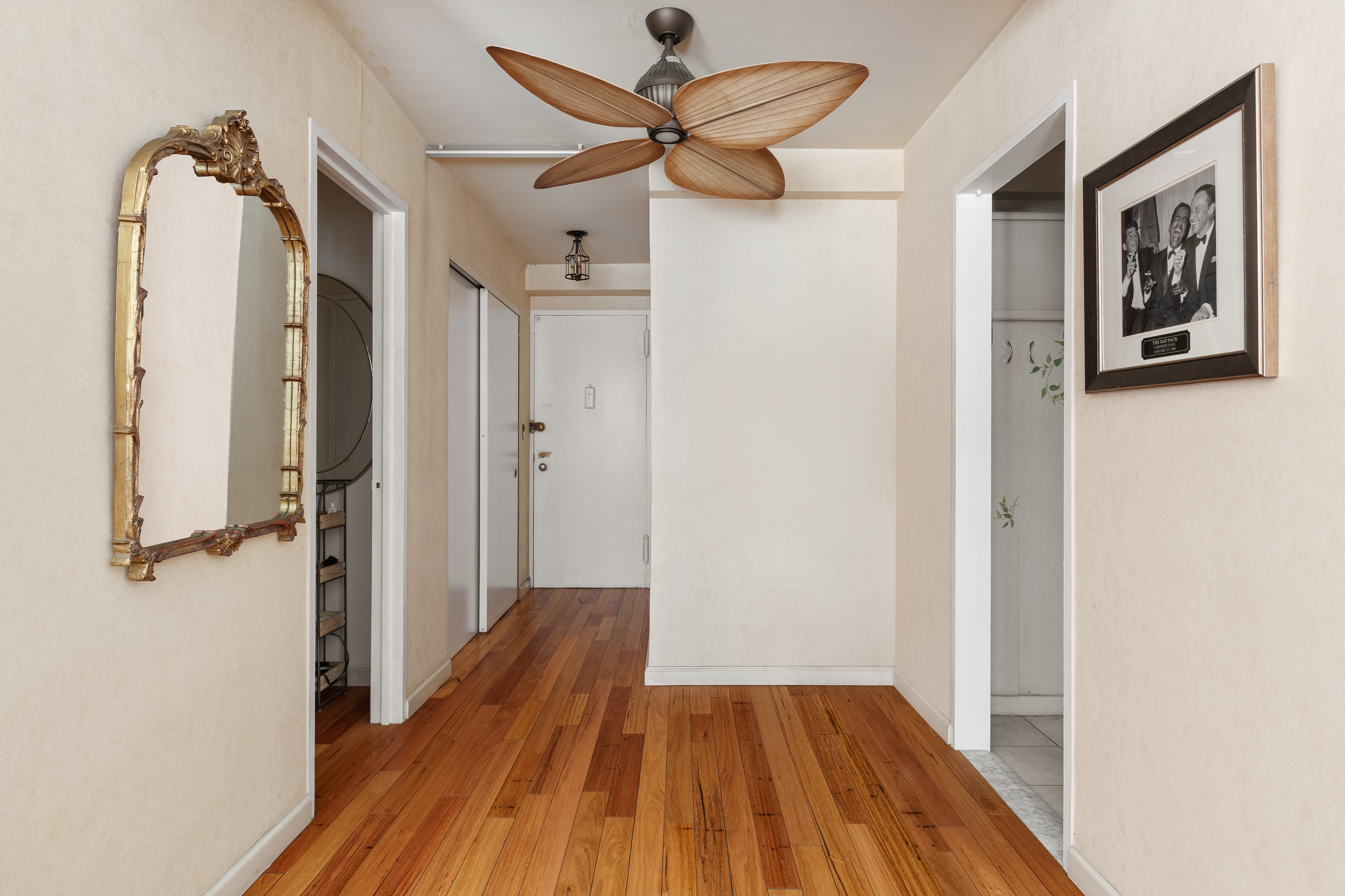310 Lexington Avenue, Unit 1B Manhattan, NY 10016 - Photo 3 of 10 a view of a hallway with wooden floor and a ceiling fan