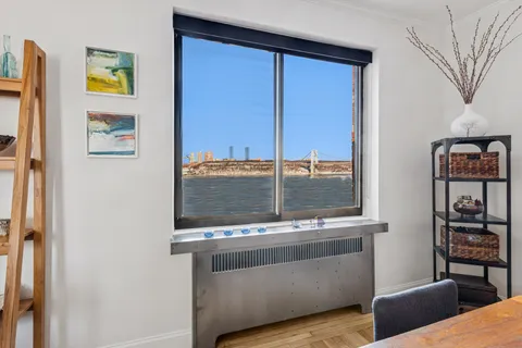 a living room with a couch and a floor to ceiling window