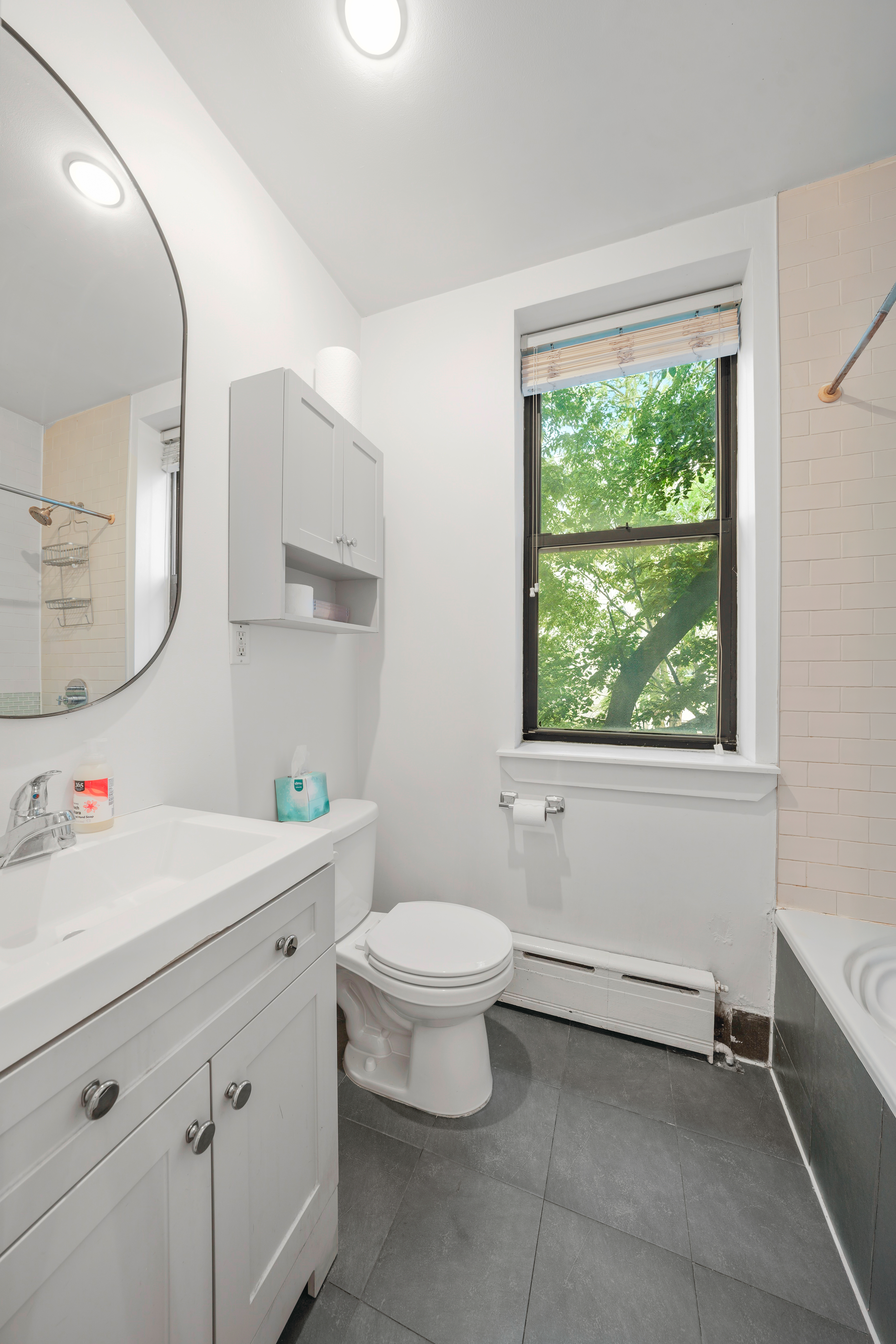 161 West 133rd Street, Unit 2B Manhattan, NY 10030 - Photo 13 of 15 a bathroom with a toilet sink and mirror
