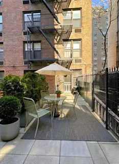 a view of a patio with couches and potted plants