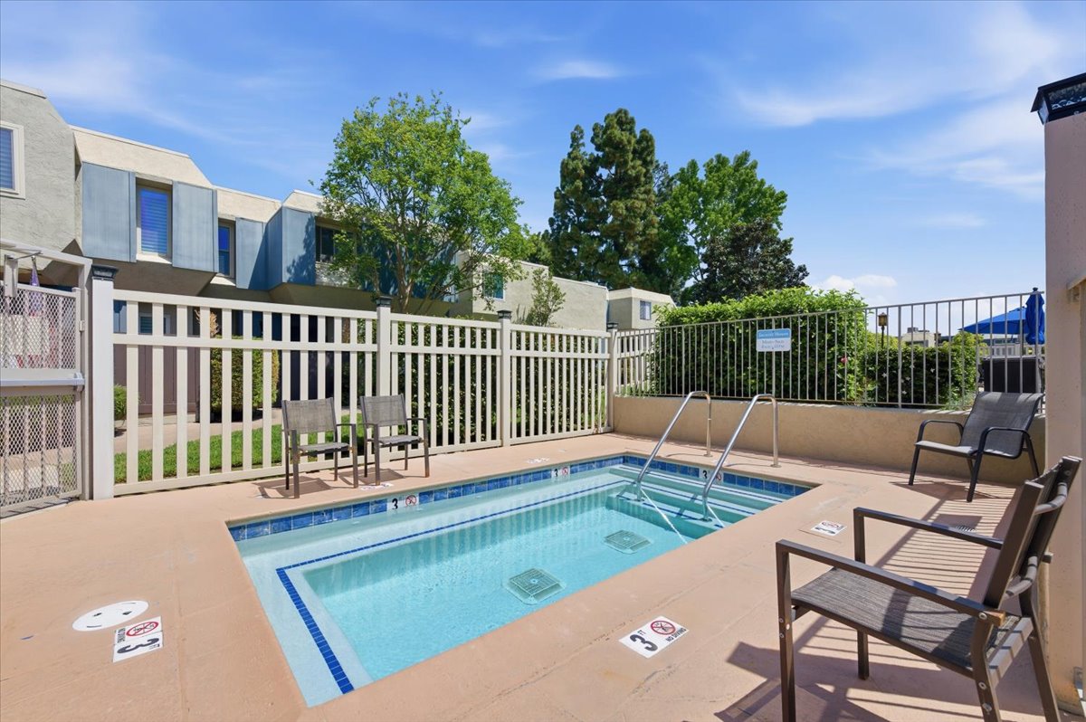 6373 Rancho Mission Road, Unit 5 San Diego, CA 92108 - Photo 25 of 30 a view of a patio with a table and chairs