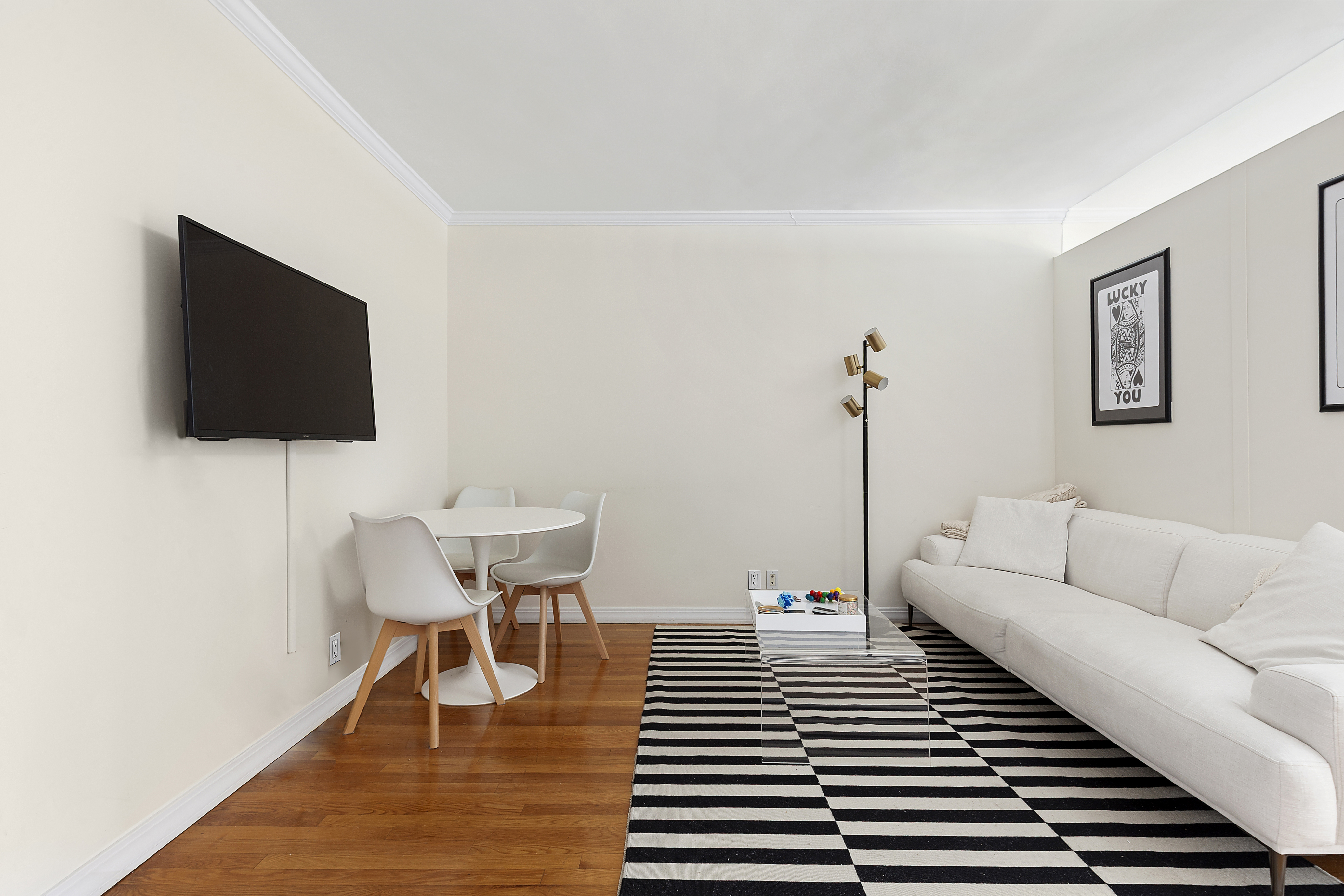 333 East 34th Street, Unit 14J Manhattan, NY 10016 - Photo 2 of 10 a living room with furniture and a flat screen tv