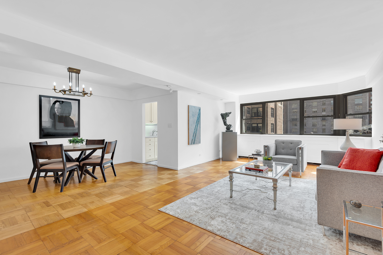 a living room with furniture and a kitchen view