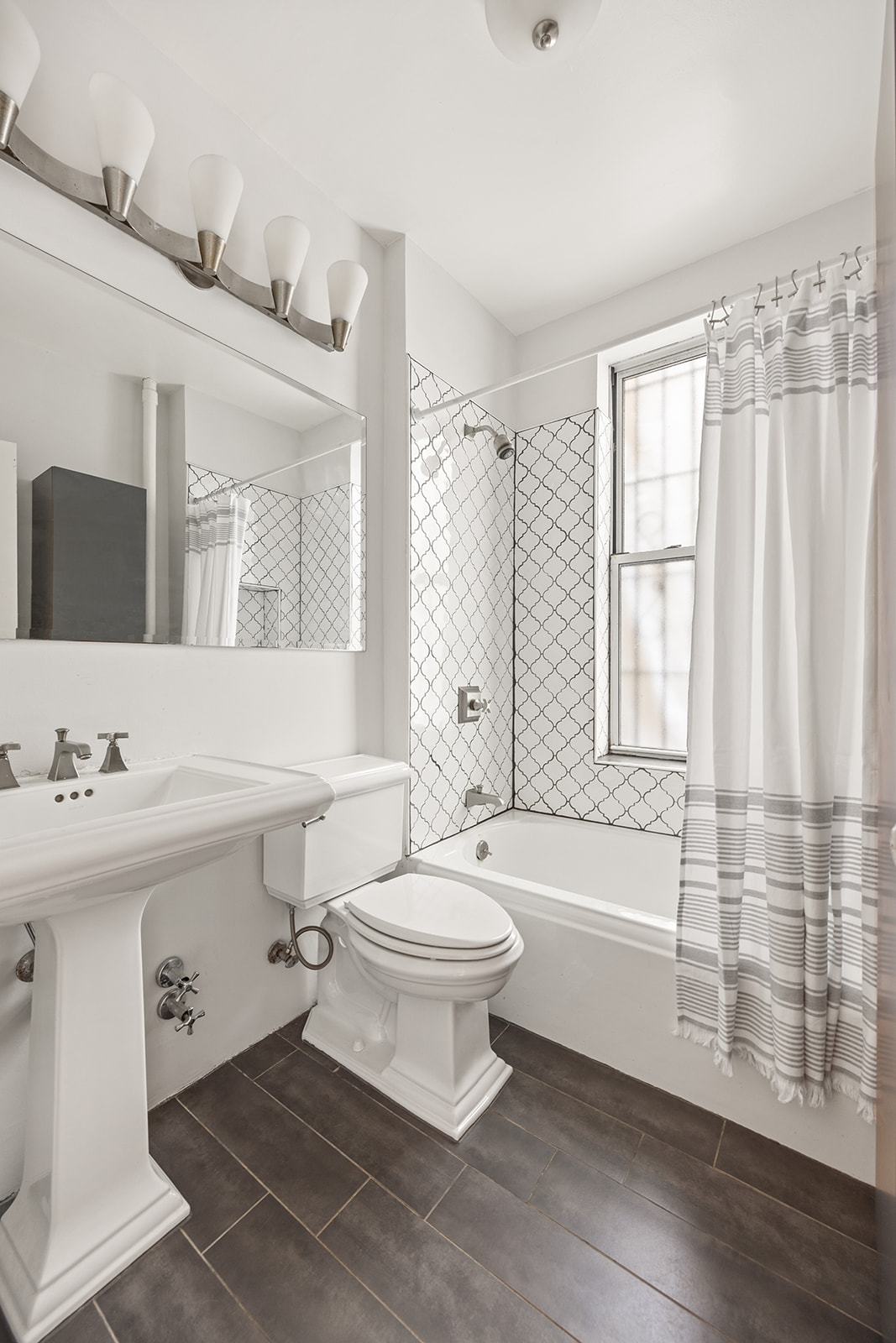 162 Garfield Place, Unit 1L Brooklyn, NY 11215 - Photo 9 of 13 a bathroom with a sink a toilet and a large mirror