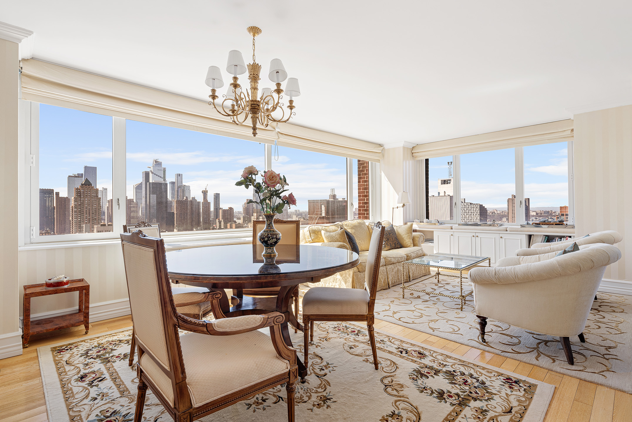 a view of a dining room with furniture a chandelier and wooden floor