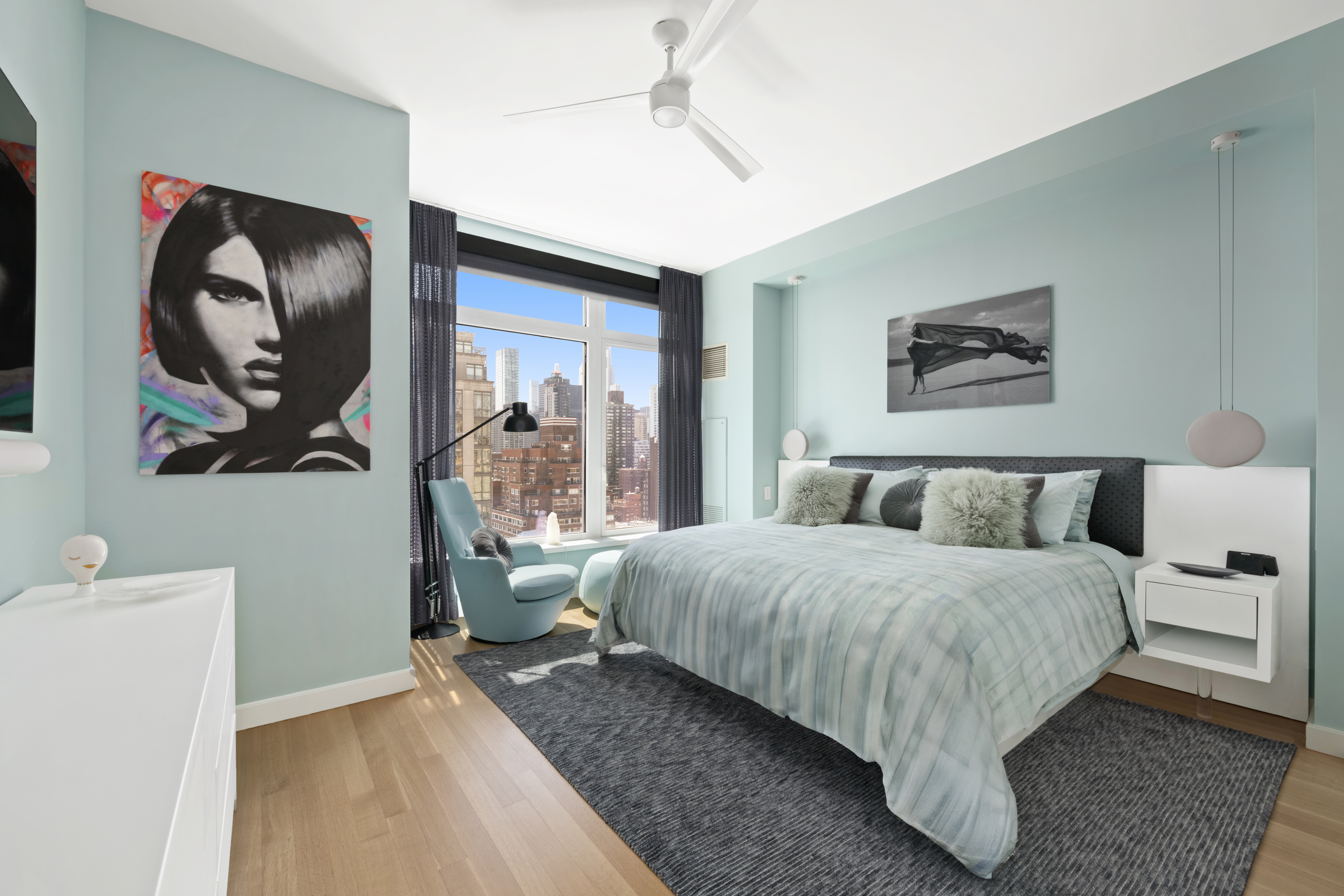 400 East 67th Street, Unit 19D Manhattan, NY 10065 - Photo 4 of 9 a bedroom with a bed and painting on the wall
