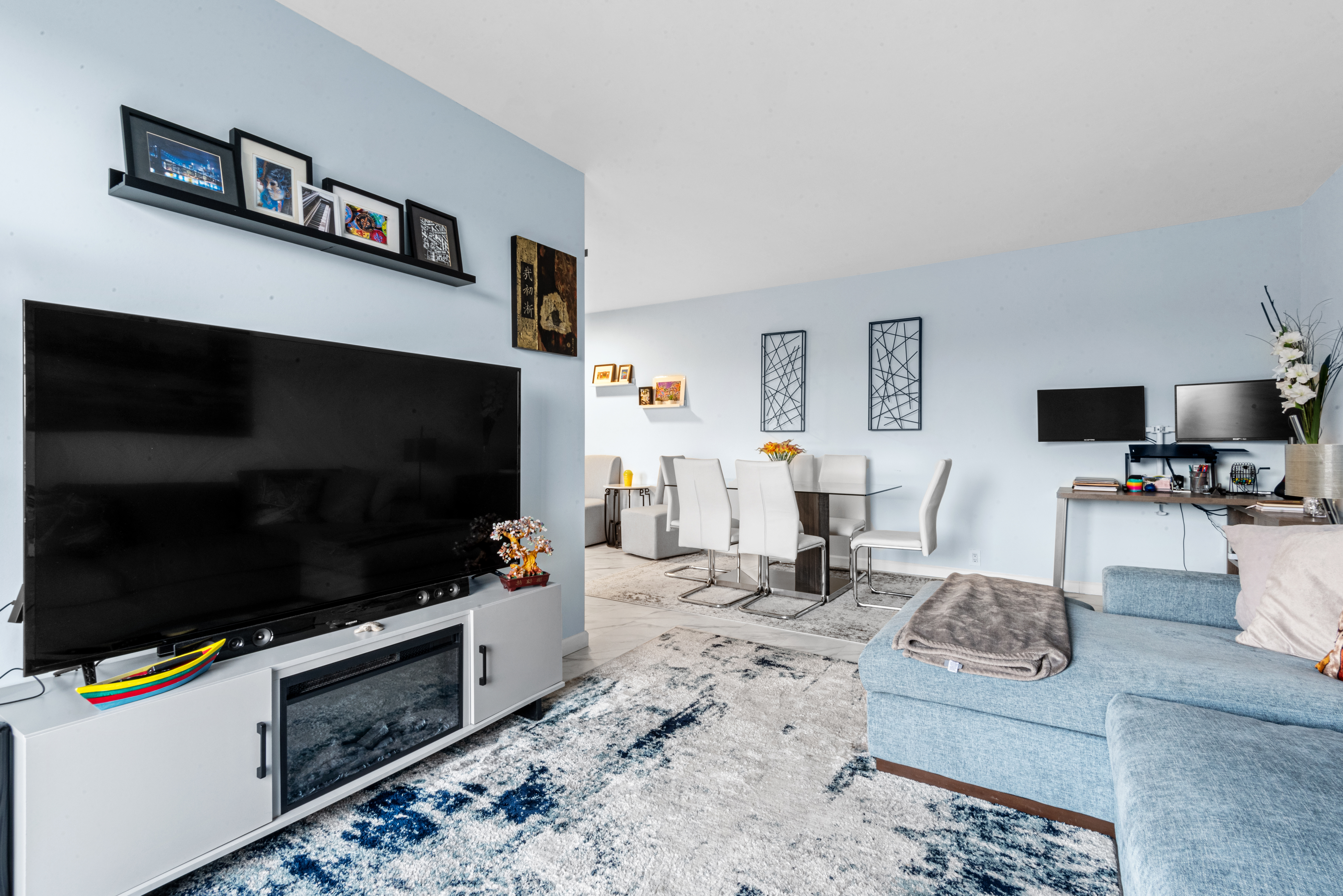 4 Horizon Road, Unit 1013 Fort Lee, NJ 07024 - Photo 8 of 18 a living room with furniture and a flat screen tv