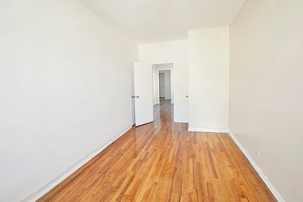 506 West 145th Street, Unit 4D Manhattan, NY 10031 - Photo 2 of 9 a view of a room with wooden floor and bench