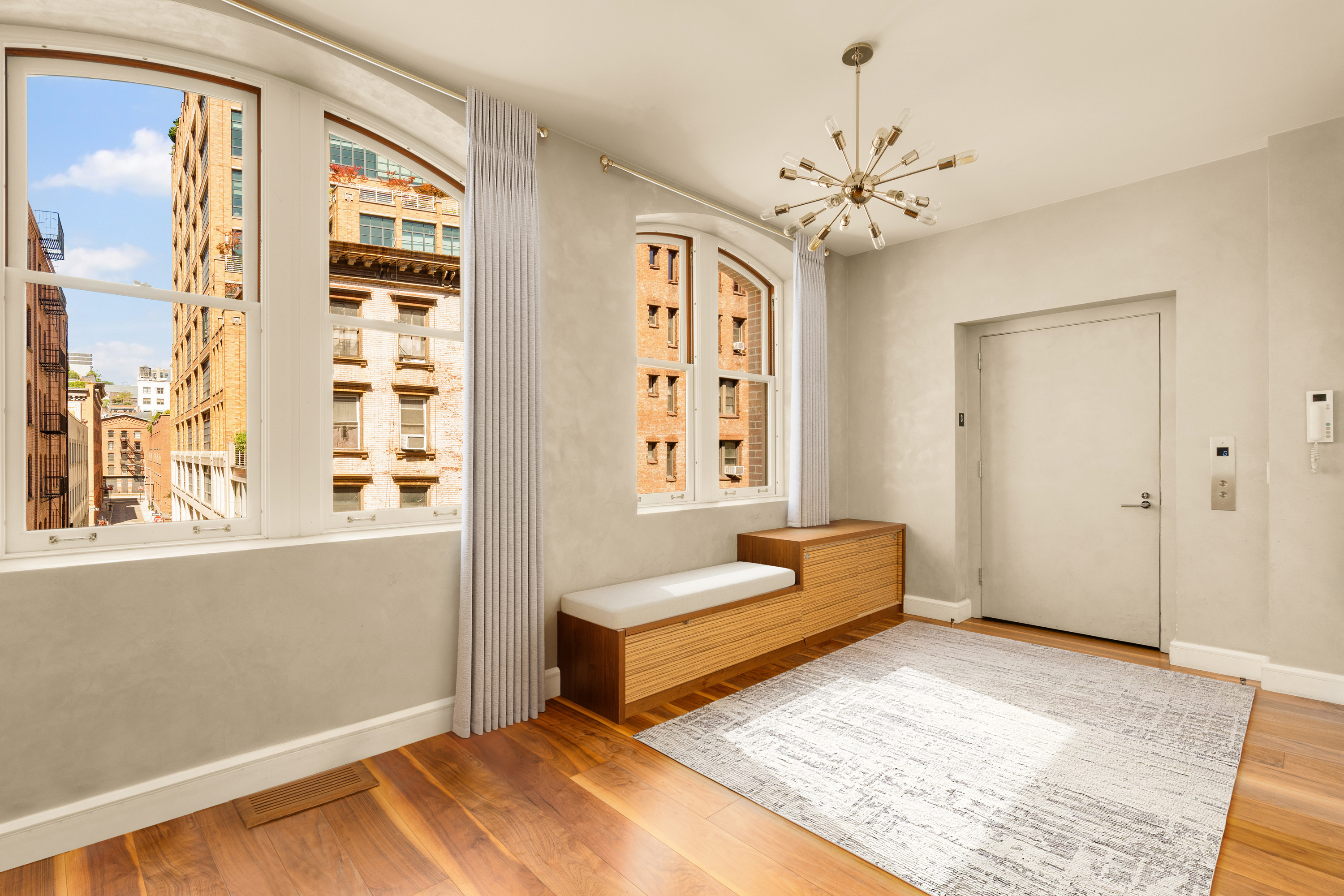 60 Beach Street, Unit 3C Manhattan, NY 10013 - Photo 10 of 12 a living room with furniture and a chandelier