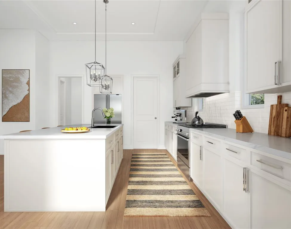 a large kitchen with stainless steel appliances a stove a sink dishwasher and white cabinets with wooden floor