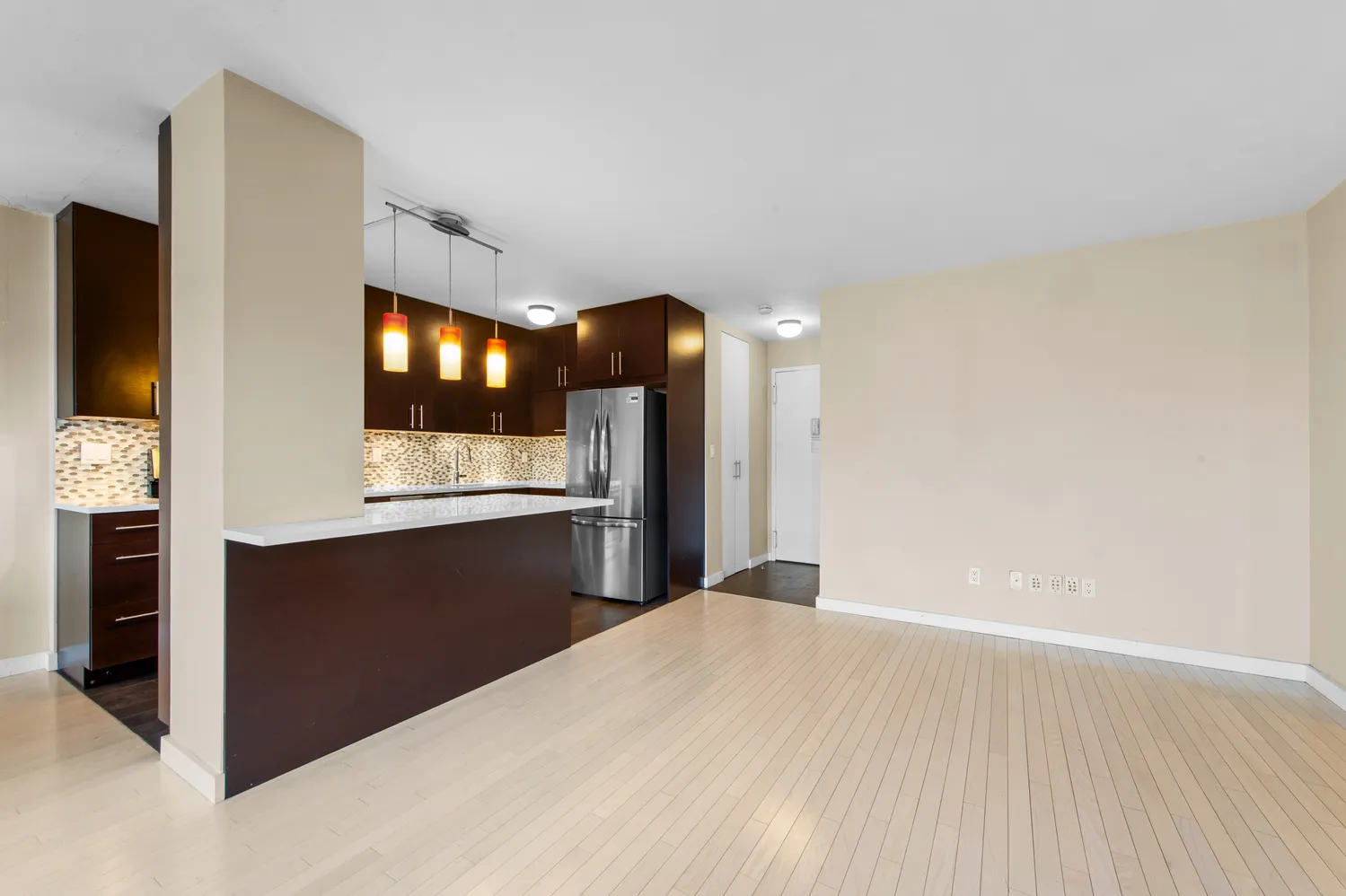 a view of kitchen with refrigerator and window