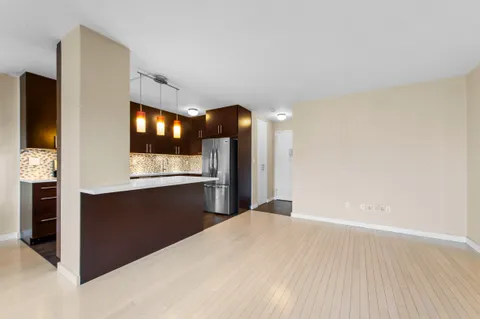 a view of kitchen with refrigerator and window