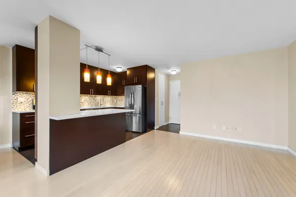 a view of kitchen with refrigerator and window