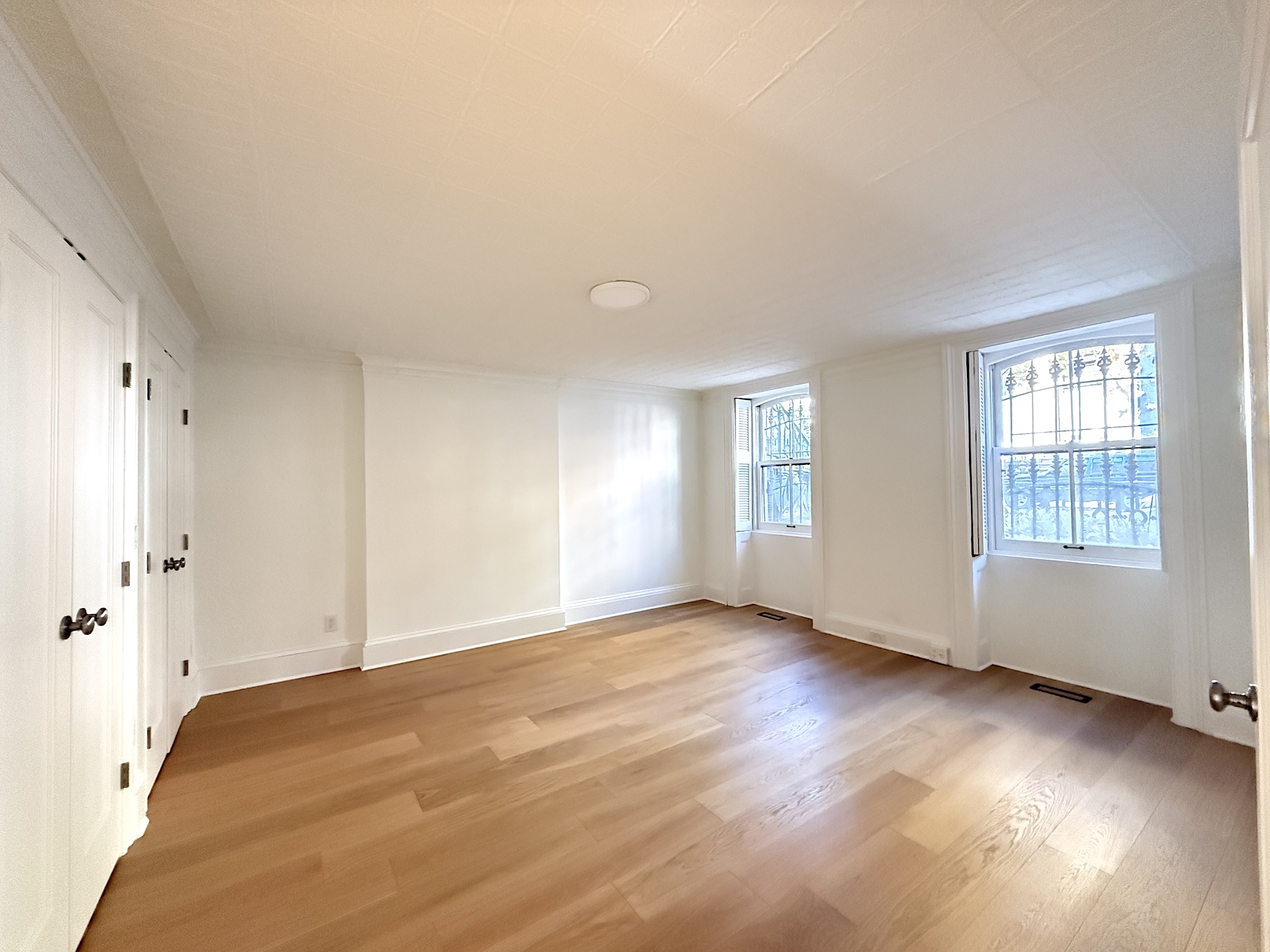 424 Pacific Street, Unit GARDEN Brooklyn, NY 11217 - Photo 8 of 16 a view of an empty room with a window and wooden floor