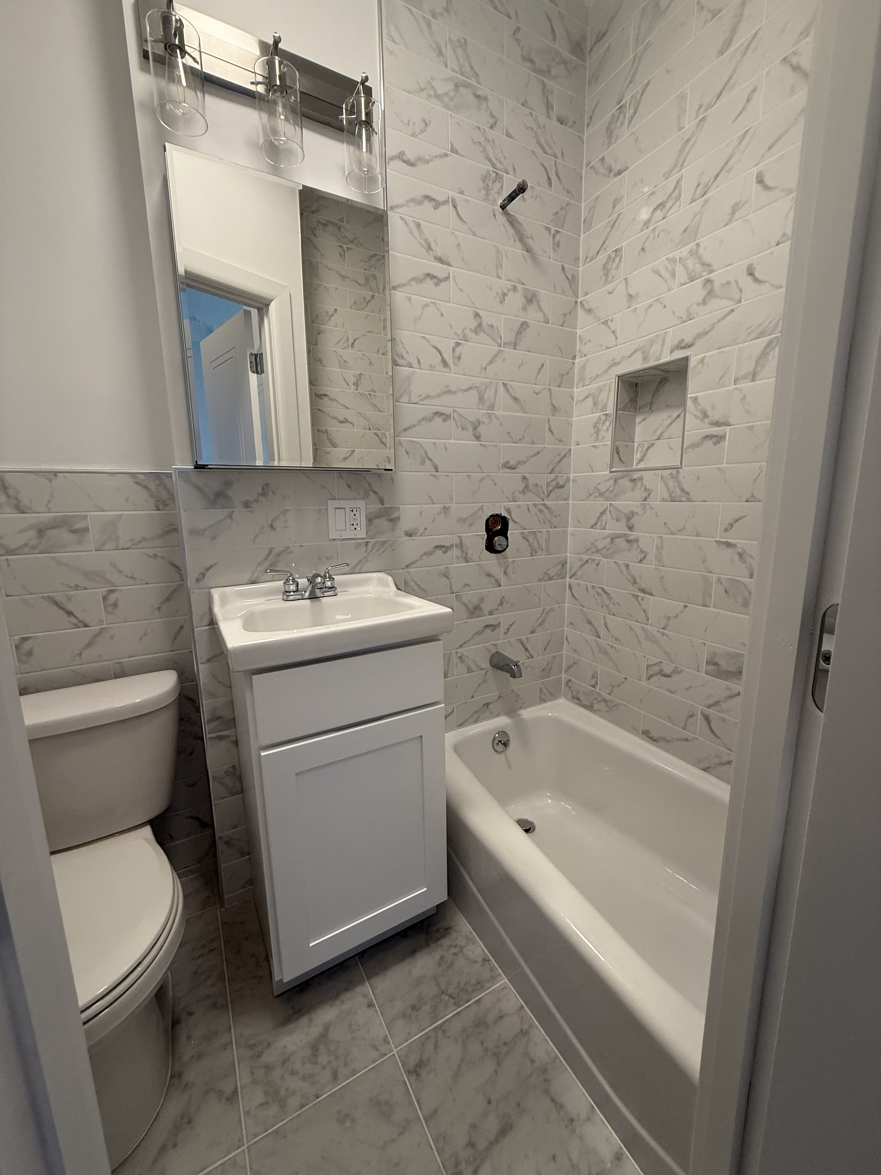 141 Summit Street, Unit 2 Brooklyn, NY 11231 - Photo 12 of 12 a bathroom with a sink a toilet and bathtub