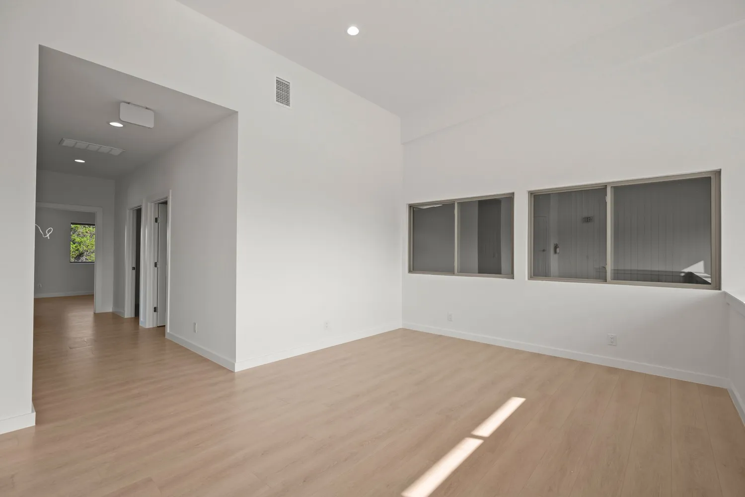 wooden floor in an empty room with a window