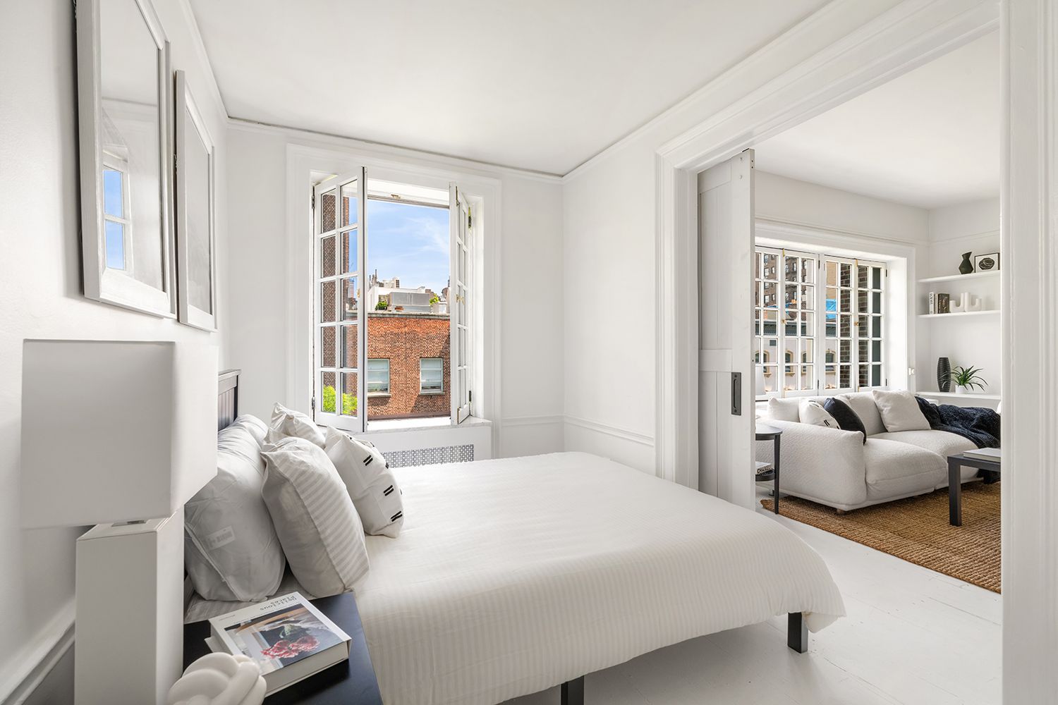 30-32 West 9th Street, Unit 5A Manhattan, NY 10011 - Photo 7 of 18 a bedroom with a bed and wooden floor