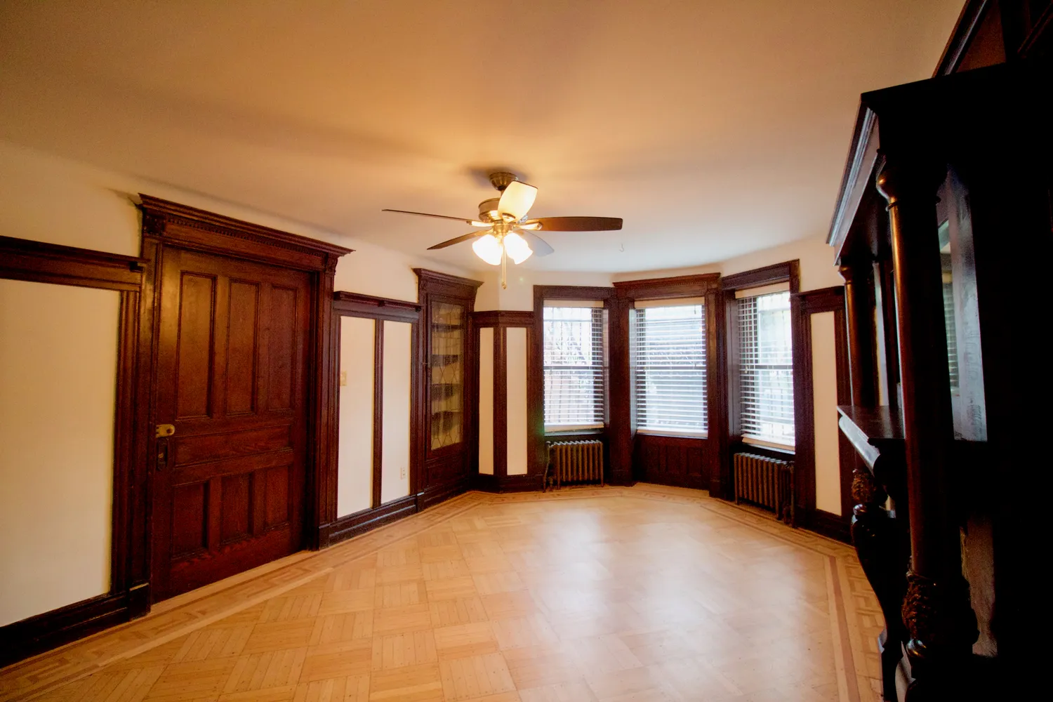 a view of a kitchen with wooden floor and a ceiling fan