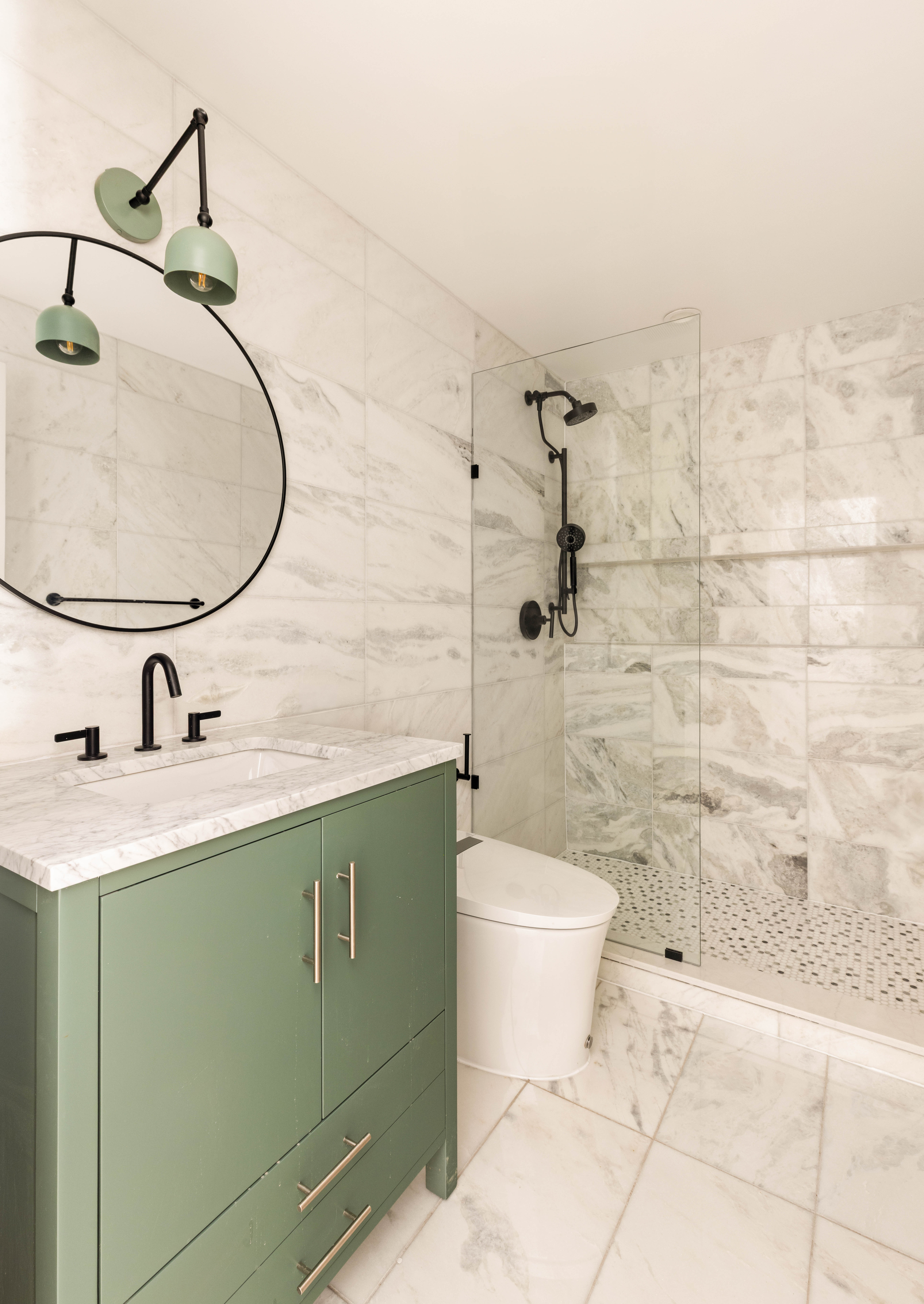 196 Monroe Street Brooklyn, NY 11216 - Photo 15 of 22 a bathroom with a granite countertop toilet sink and mirror