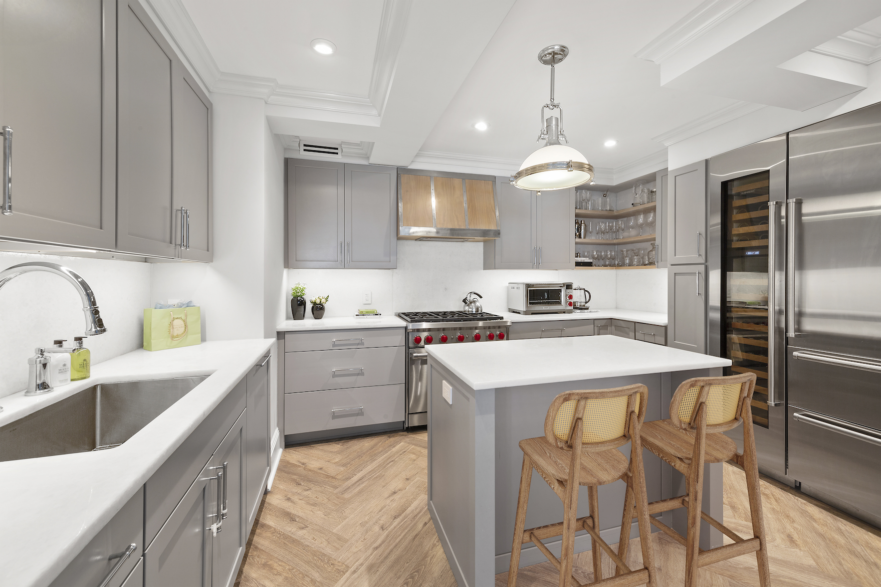 110 East 57th Street, Unit 10CD Manhattan, NY 10022 - Photo 5 of 16 a kitchen that has a lot of cabinets in it and appliances