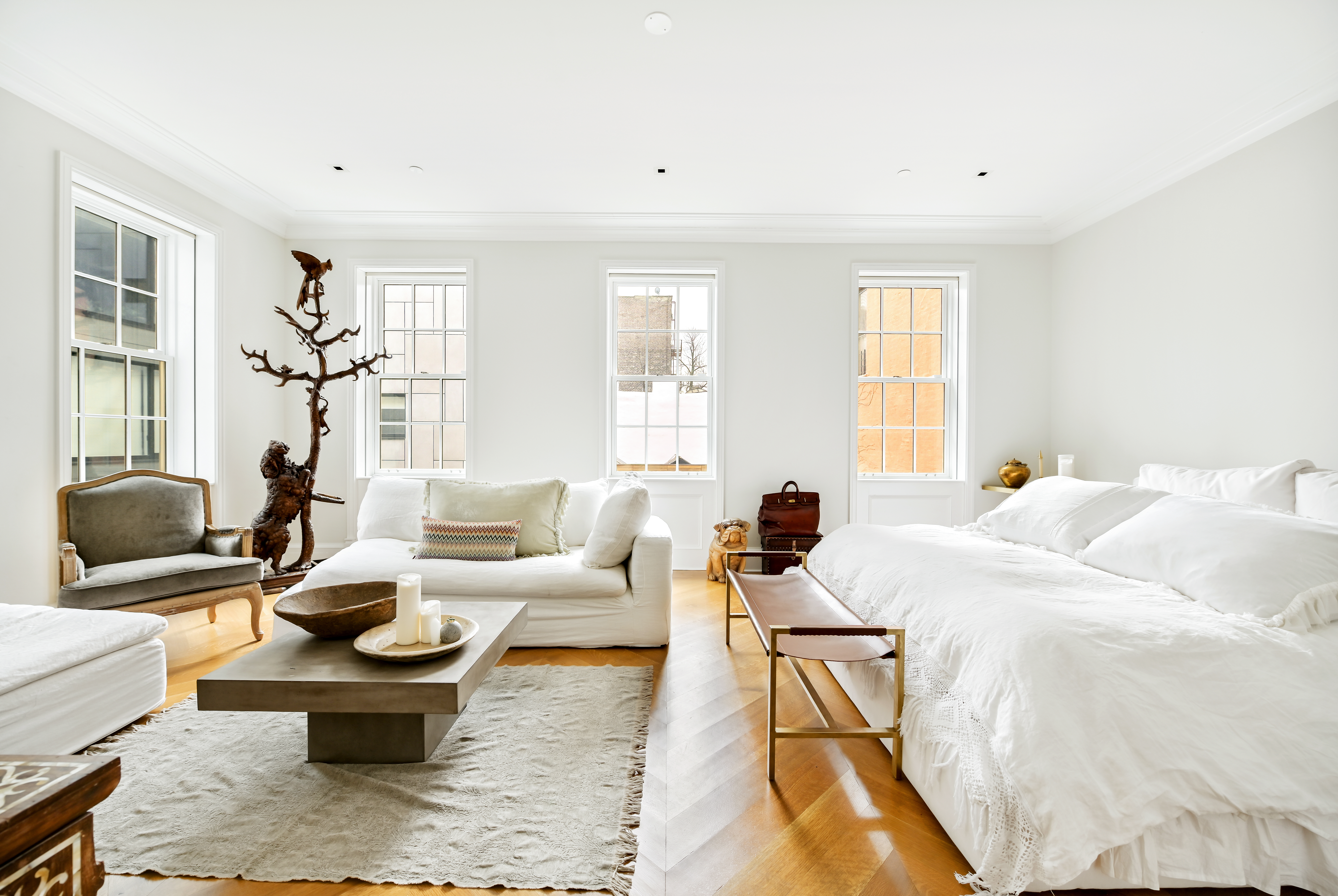 38 Prince Street Manhattan, NY 10012 - Photo 3 of 17 a bedroom with a bed couch and wooden floor