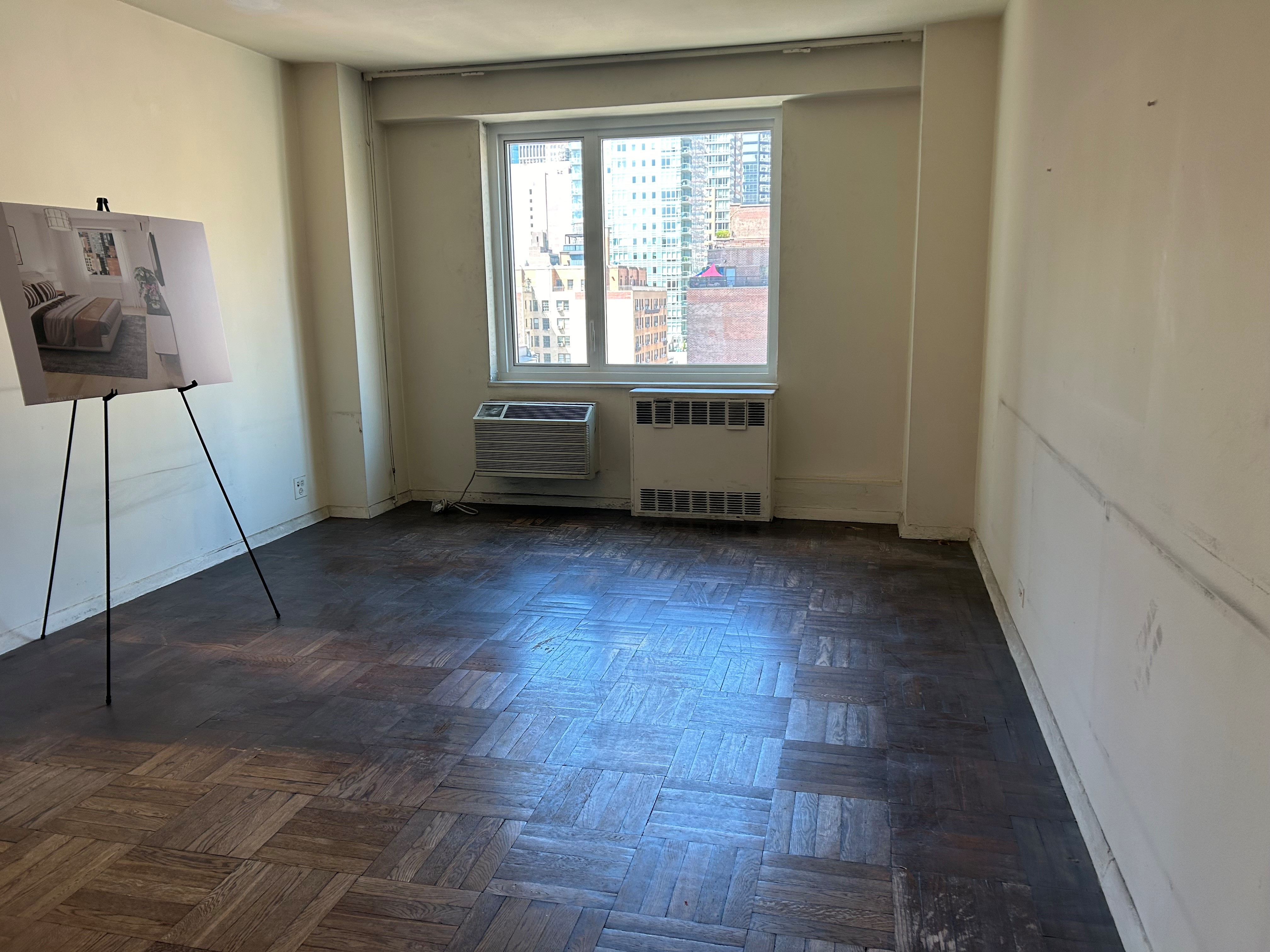 411 East 53rd Street, Unit 11K Manhattan, NY 10022 - Photo 10 of 19 a view of room with window and hardwood floor