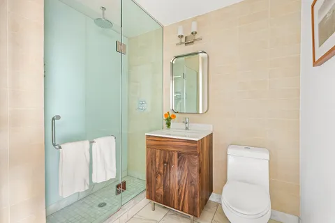 a bathroom with a toilet a sink and mirror