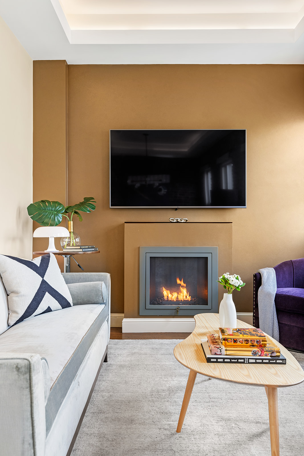 77 Perry Street, Unit 6CD Manhattan, NY 10014 - Photo 5 of 16 a living room with furniture a flat screen tv and a fireplace