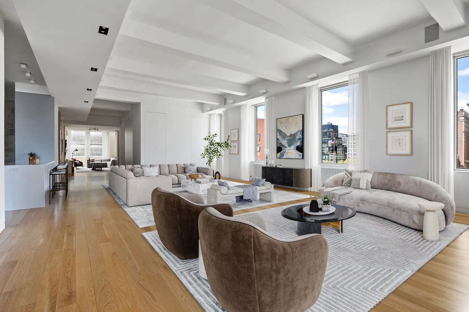 a living room with furniture kitchen view and a large window