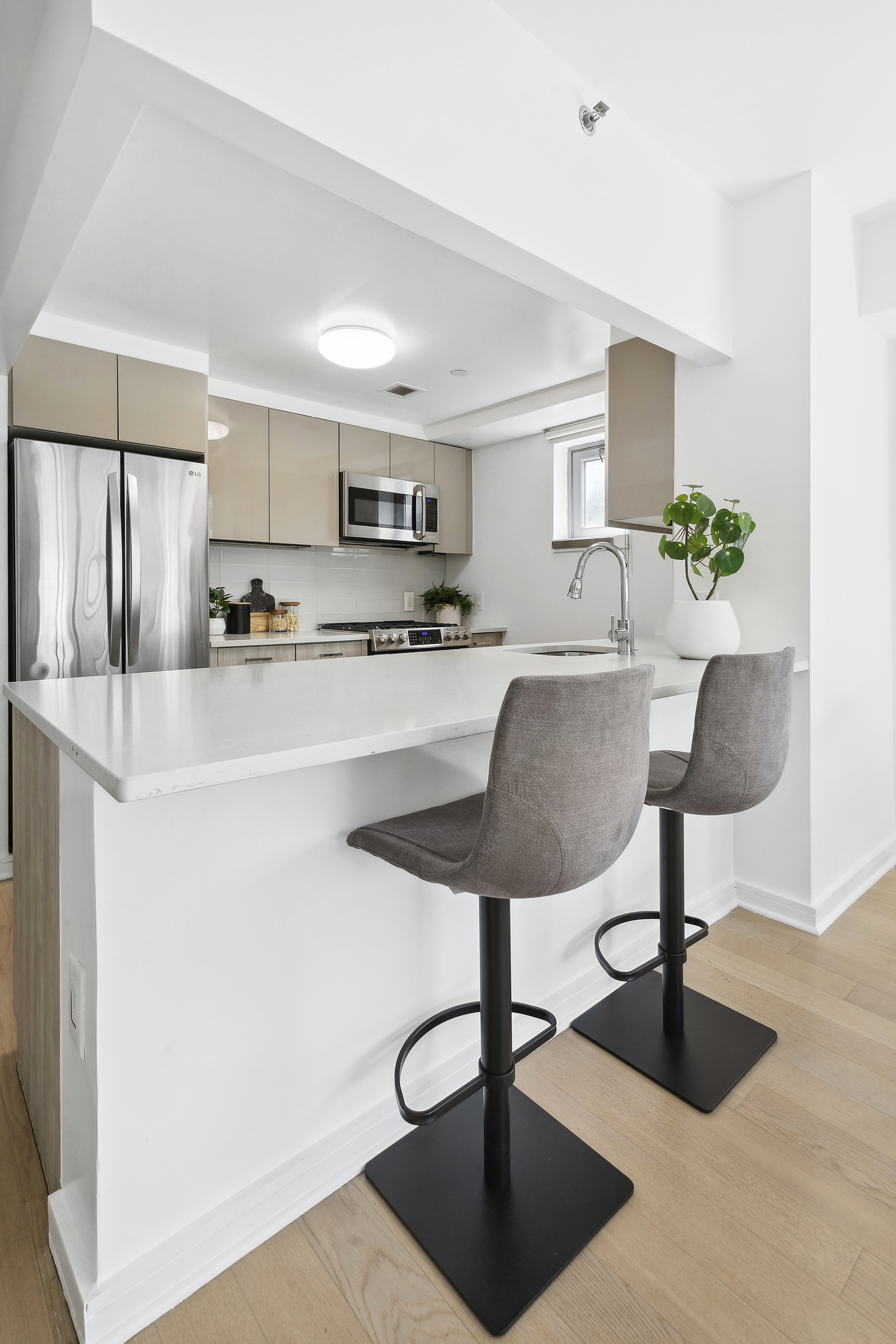 171 West 131st Street, Unit 407 Manhattan, NY 10027 - Photo 3 of 18 a kitchen with stainless steel appliances granite countertop a refrigerator and a stove top oven