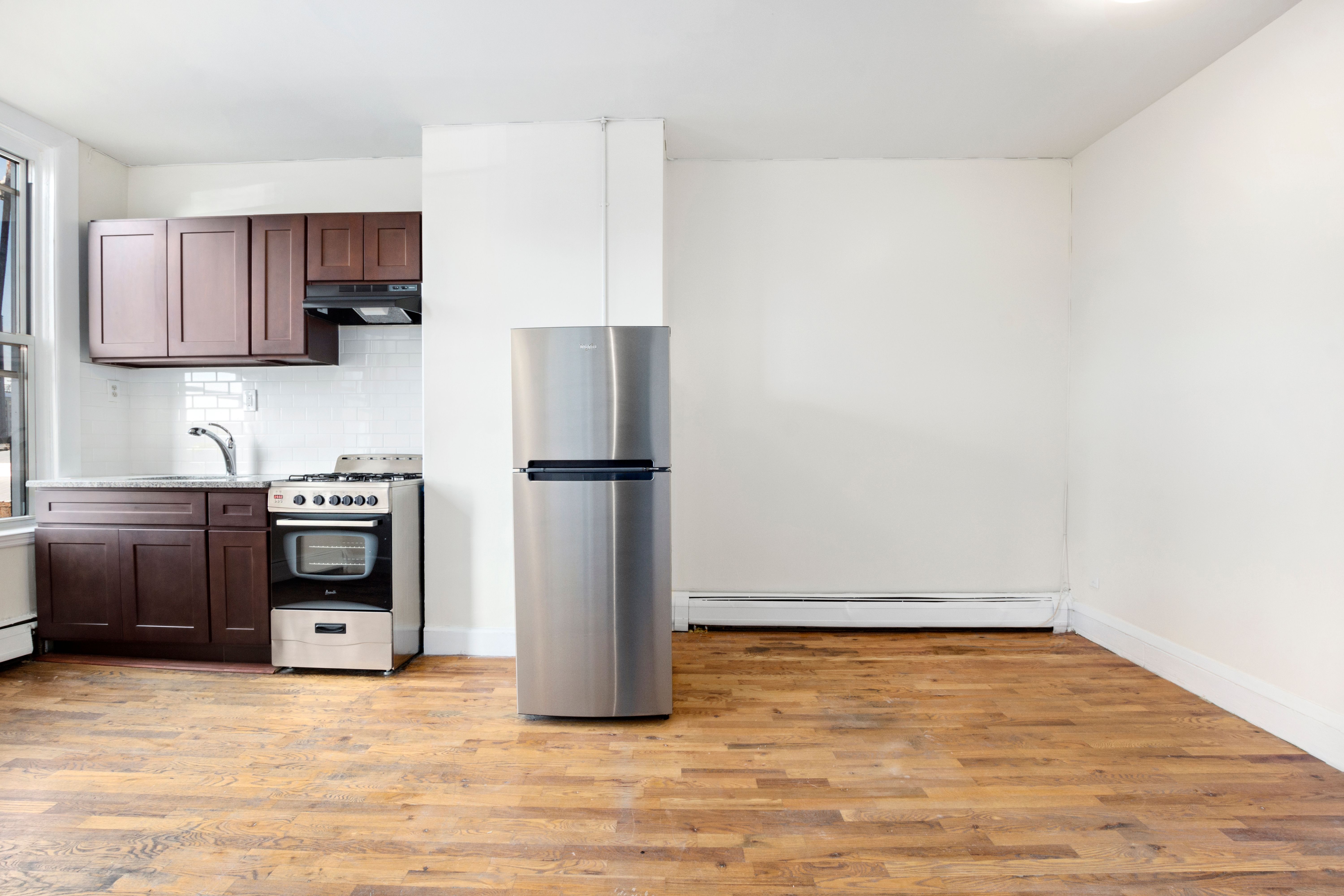 148 29th Street Brooklyn, NY 11232 - Photo 5 of 31 a kitchen with stainless steel appliances a refrigerator and a stove