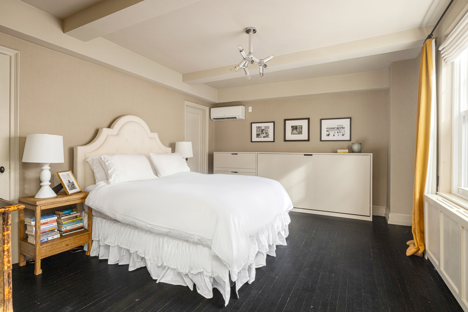 45 Christopher Street, Unit 2E Manhattan, NY 10014 - Photo 11 of 15 a bedroom with a bed and a chandelier