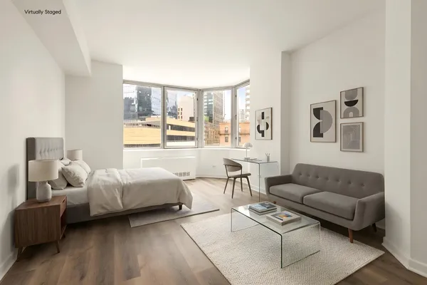 a bedroom with furniture and a large window