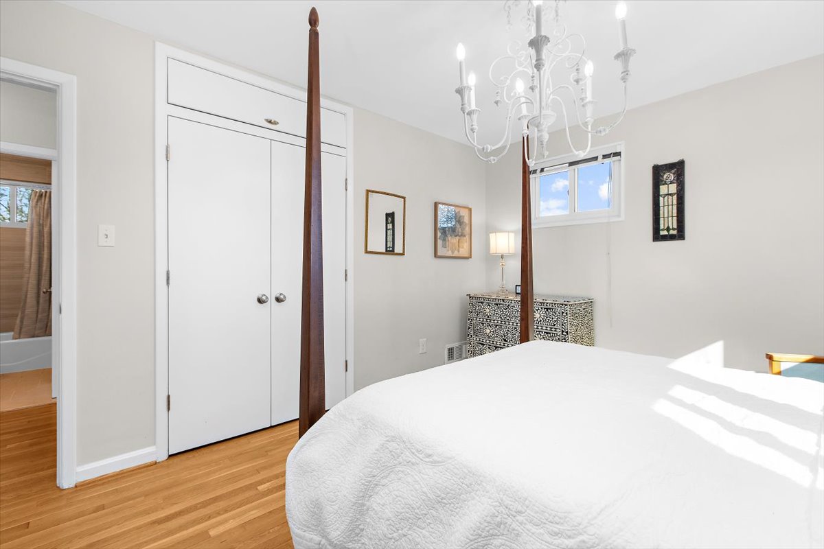 12712 Atherton Drive Silver Spring, MD 20906 - Photo 15 of 40 a spacious bedroom with a bed and a chandelier