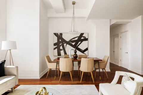 a dining room with furniture and wooden floor