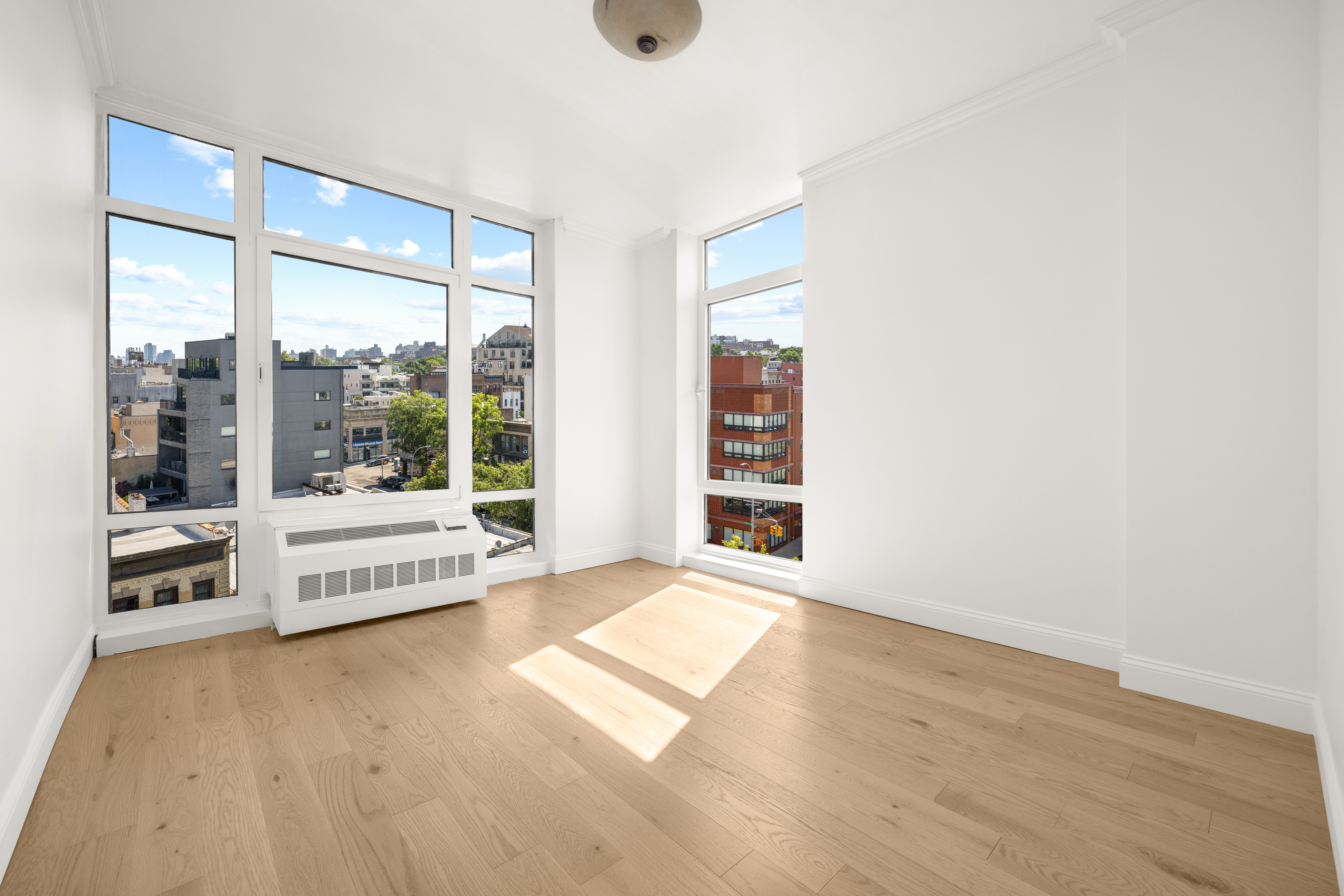162 16th Street, Unit 7E Brooklyn, NY 11215 - Photo 6 of 23 a view of an empty room with window and a kitchen view