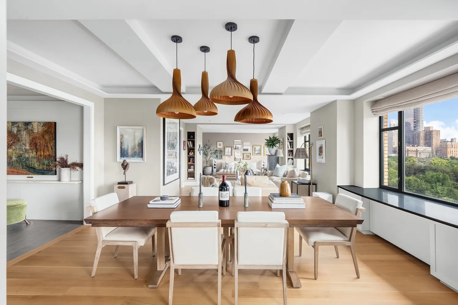 a dining room with furniture a chandelier and wooden floor