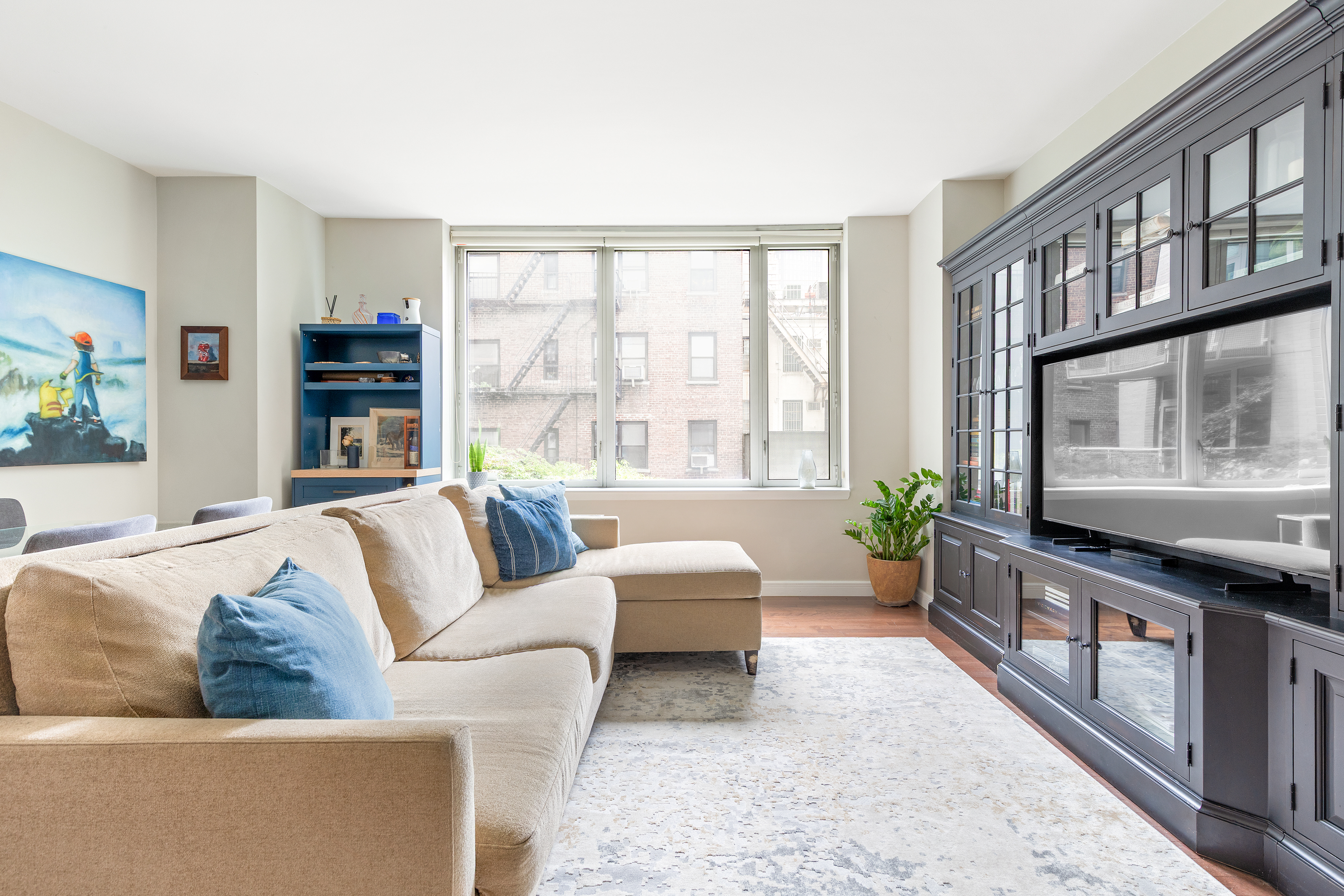 225 East 34th Street, Unit 3K Manhattan, NY 10016 - Photo 1 of 19 a living room with furniture and a large window