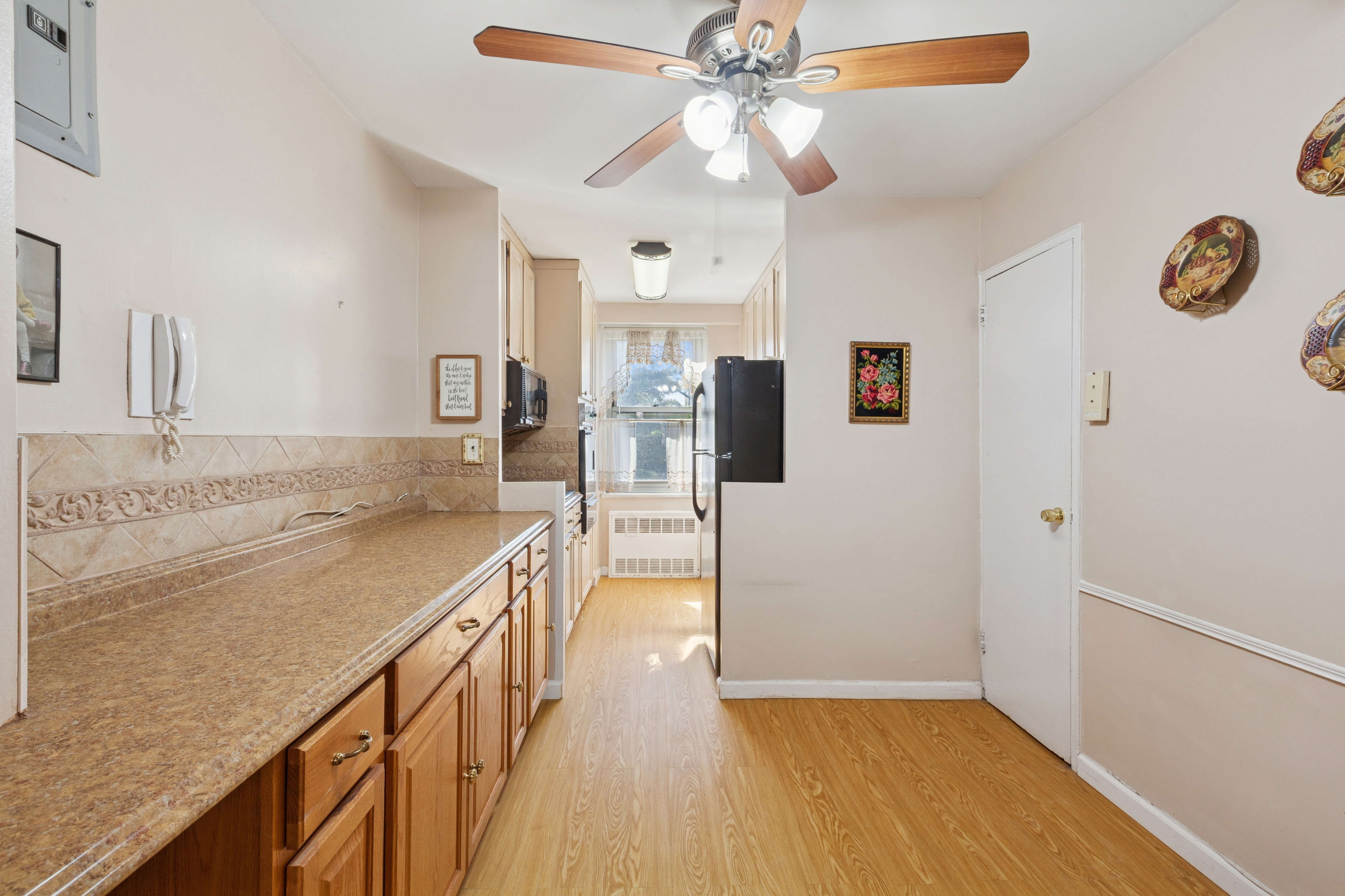 70-25 Yellowstone Boulevard, Unit 2M Queens, NY 11375 - Photo 8 of 23 a view of a kitchen cabinets a sink and dishwasher
