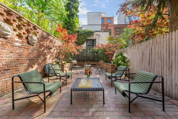 a backyard of a house with table and chairs