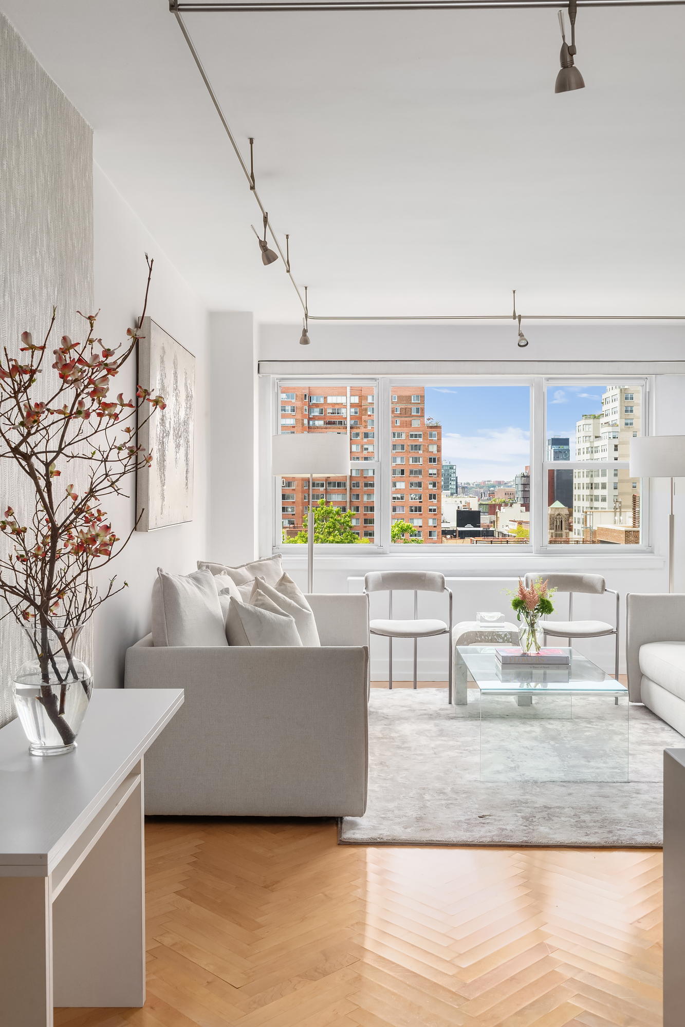 101 West 12th Street, Unit 12B Manhattan, NY 10011 - Photo 3 of 10 a living room with furniture and a large window