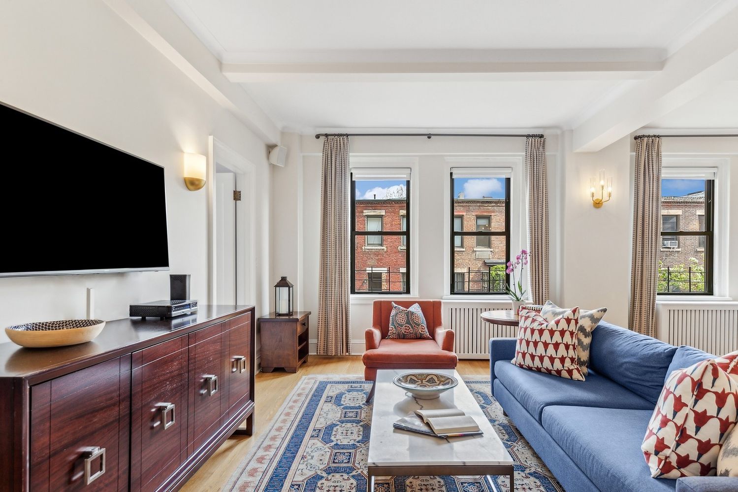 a living room with furniture and a flat screen tv