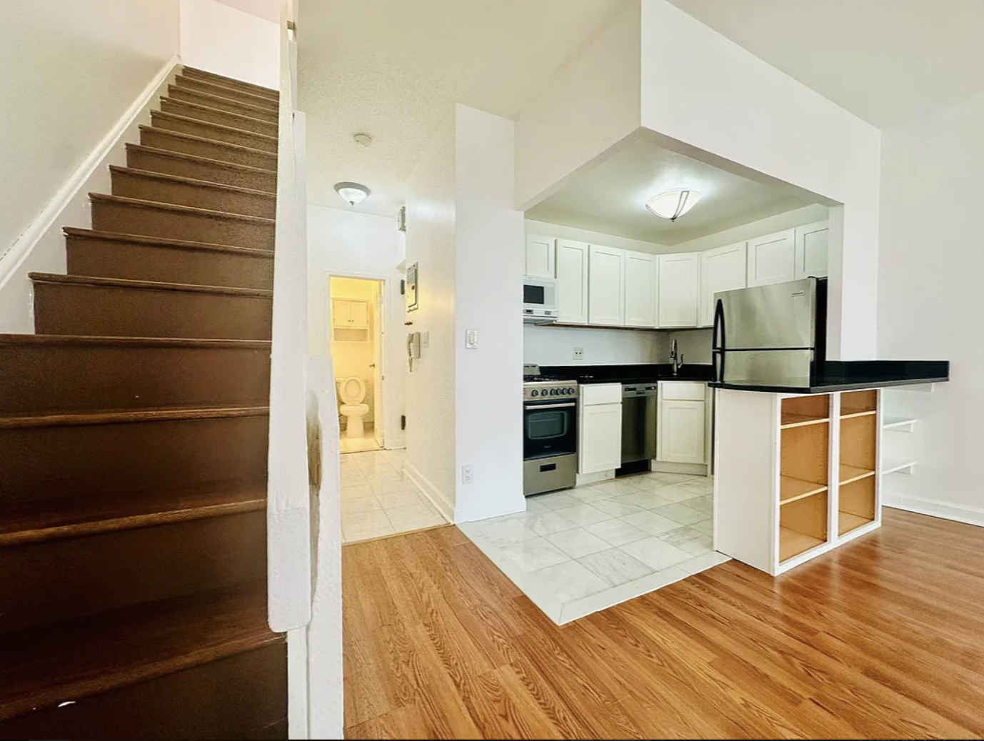 305 East 95th Street, Unit 6E Manhattan, NY 10128 - Photo 2 of 9 a view of kitchen with wooden floor and electronic appliances