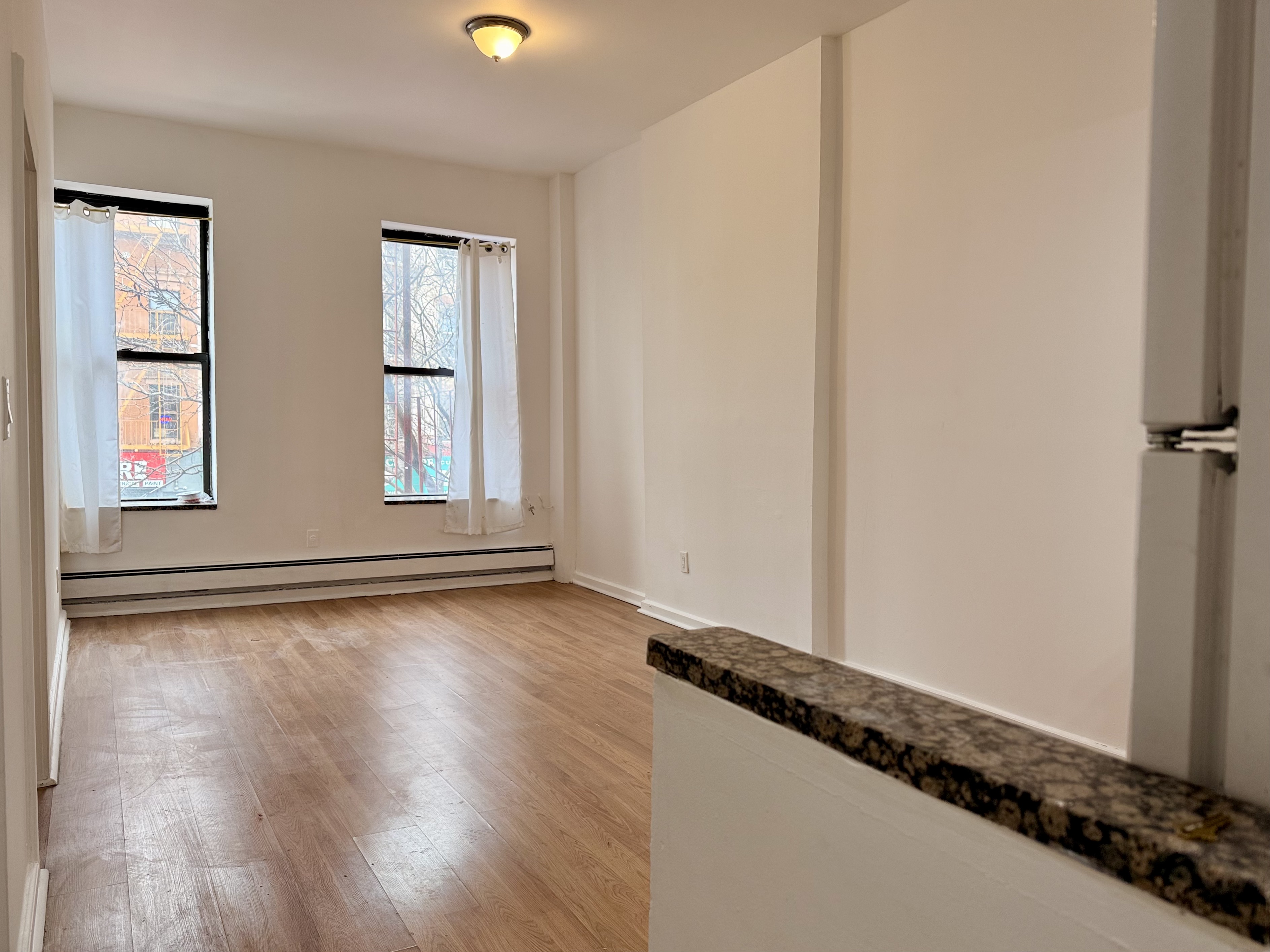 1997 3rd Avenue, Unit 1A Manhattan, NY 10029 - Photo 3 of 23 a view of an empty room and window