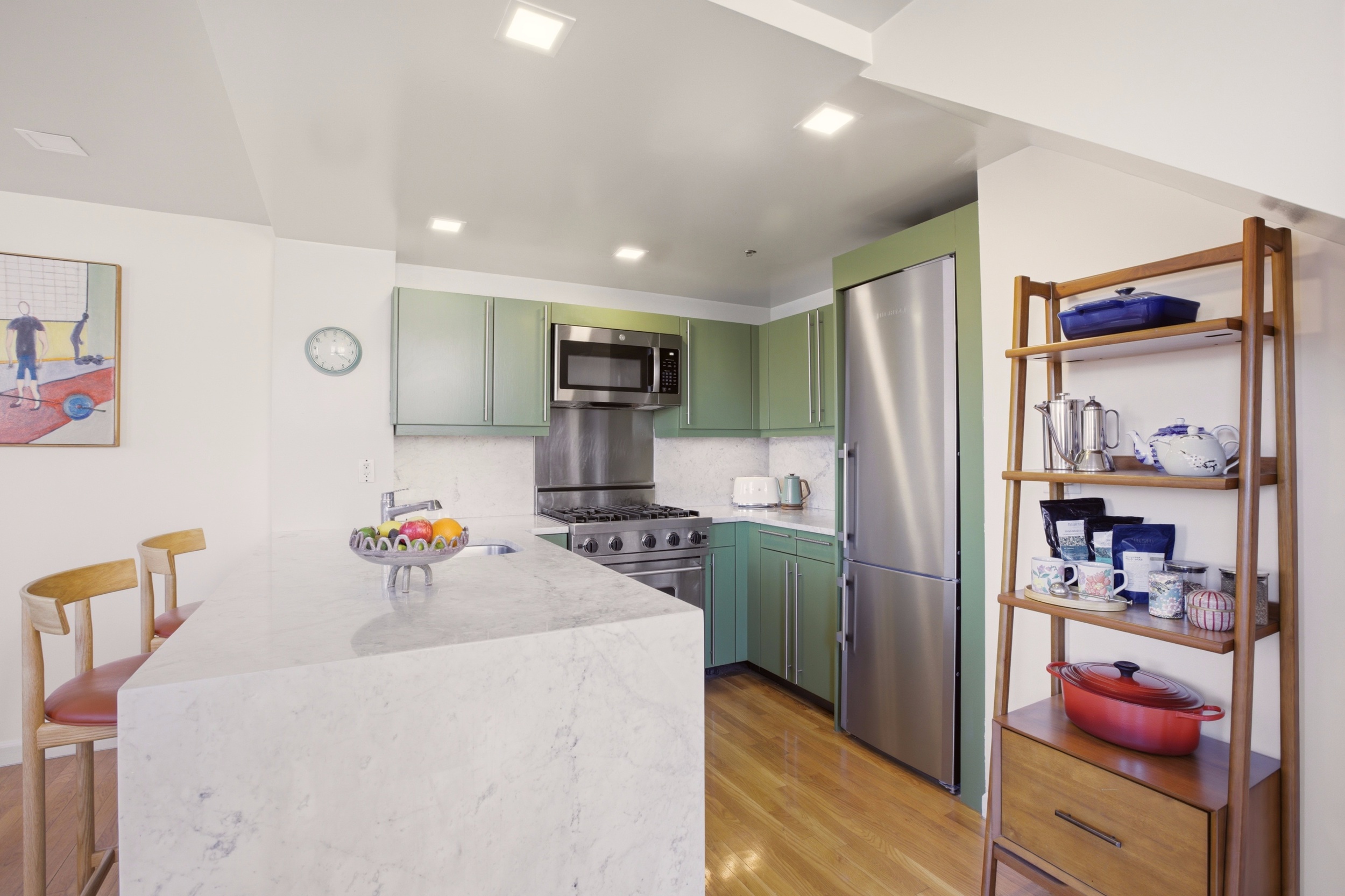 305 2nd Avenue, Unit 521 Manhattan, NY 10003 - Photo 5 of 20 a room with furniture a washer and dryer