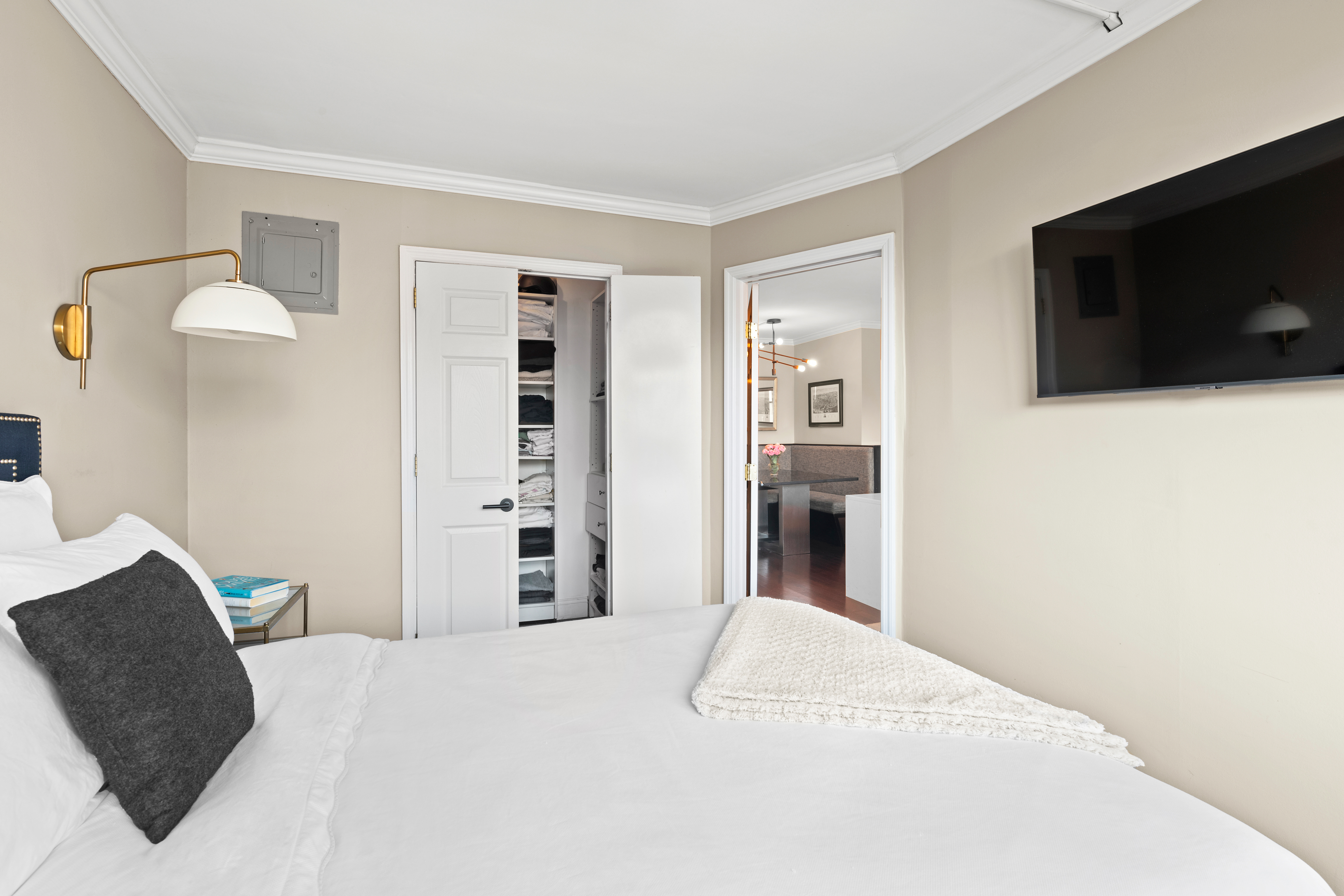 200 East 24th Street, Unit 1807 Manhattan, NY 10010 - Photo 7 of 10 a bedroom with a bed and a television